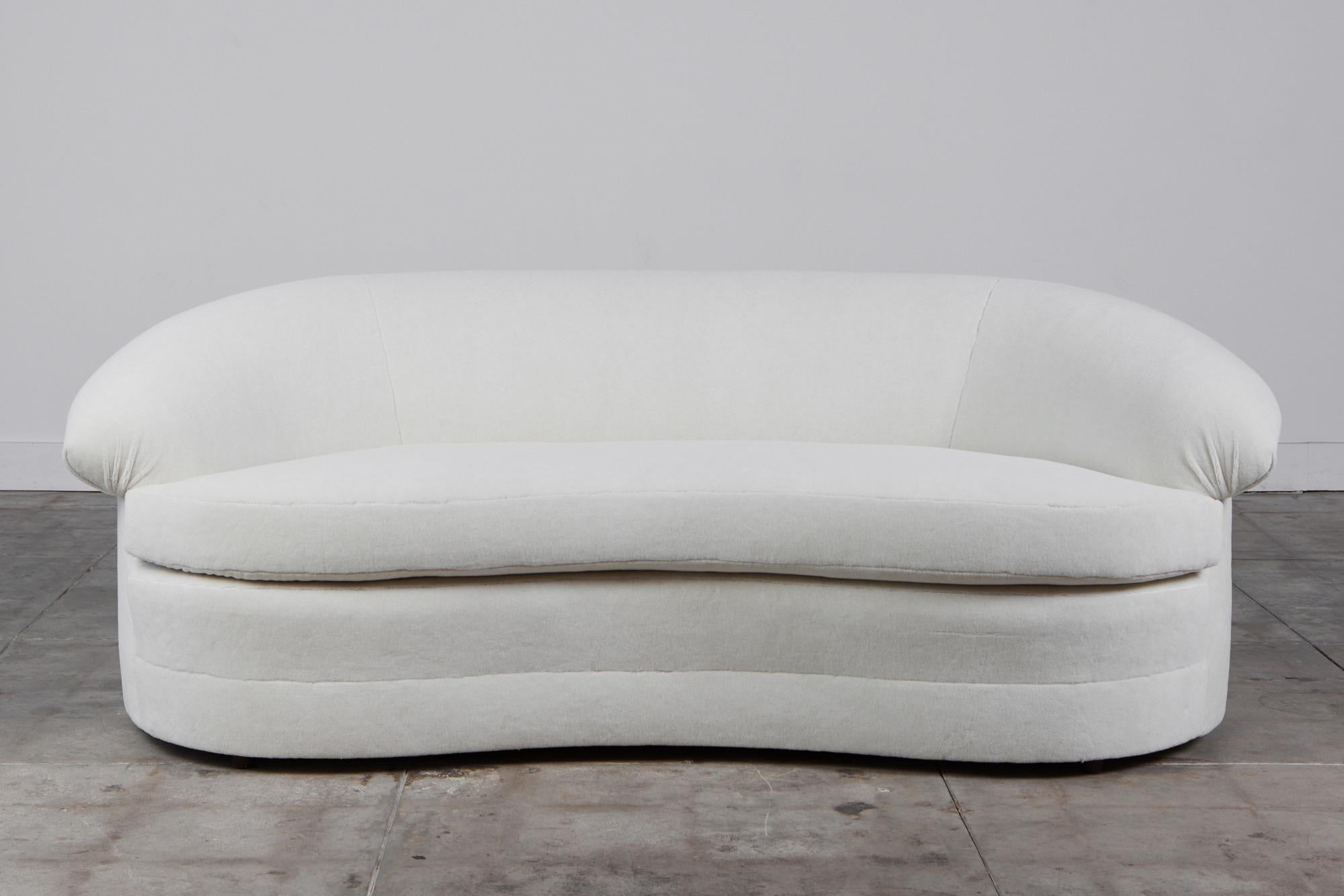 Large curved sofa inspired by Italian mid-century design, USA, c.1980s. Its sensuous curves and voluptuous shape makes it a statement piece in any interior. It is upholstered in a beautiful high pile Italian velvet alpaca. The deep seating along