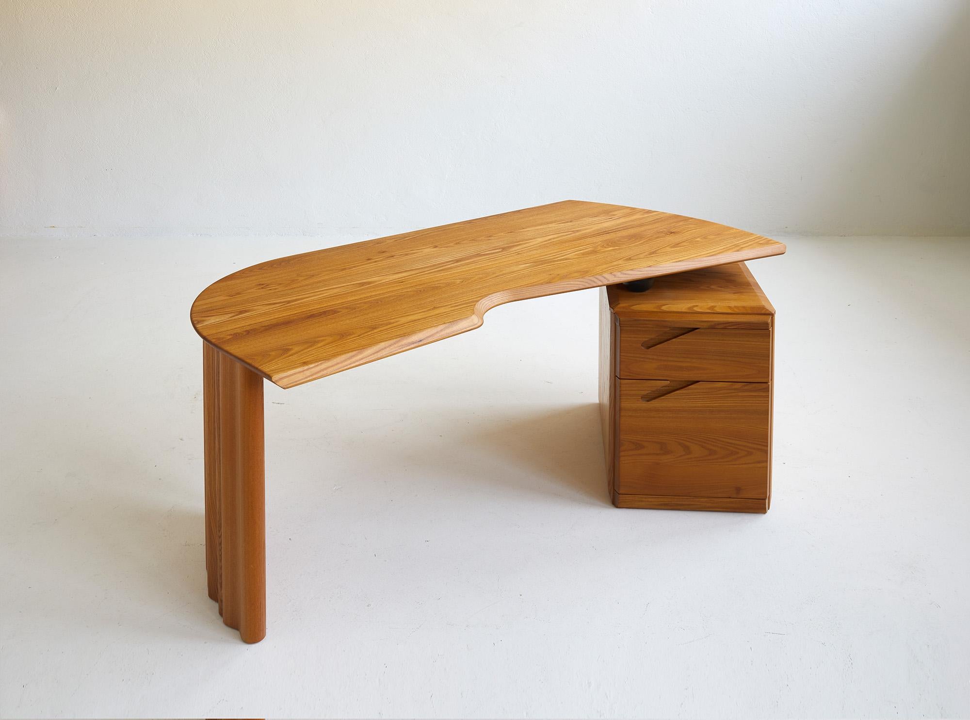 This desk in solid elmwood has been made by the French company Ebenisterie Seltz situated in the eastern part of the country which has been widely known for producing certain designs by Pierre Chapo during the 1970's and 1980's. 

Chapo chose to
