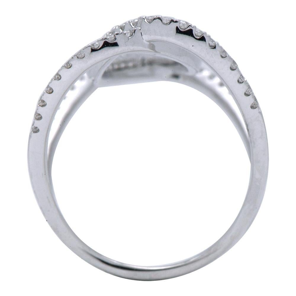 This modern beautiful ring is made from 3.5 grams of 18 karat white gold. There are 66 round VS2, G color diamonds totaling 0.27 carats which make up a large curved 