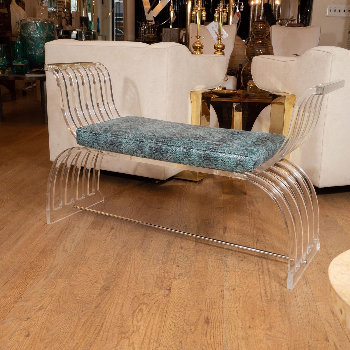 Curvilinear lucite and chrome bench attributed to Karl Springer. Upholstered in snakeskin print. 