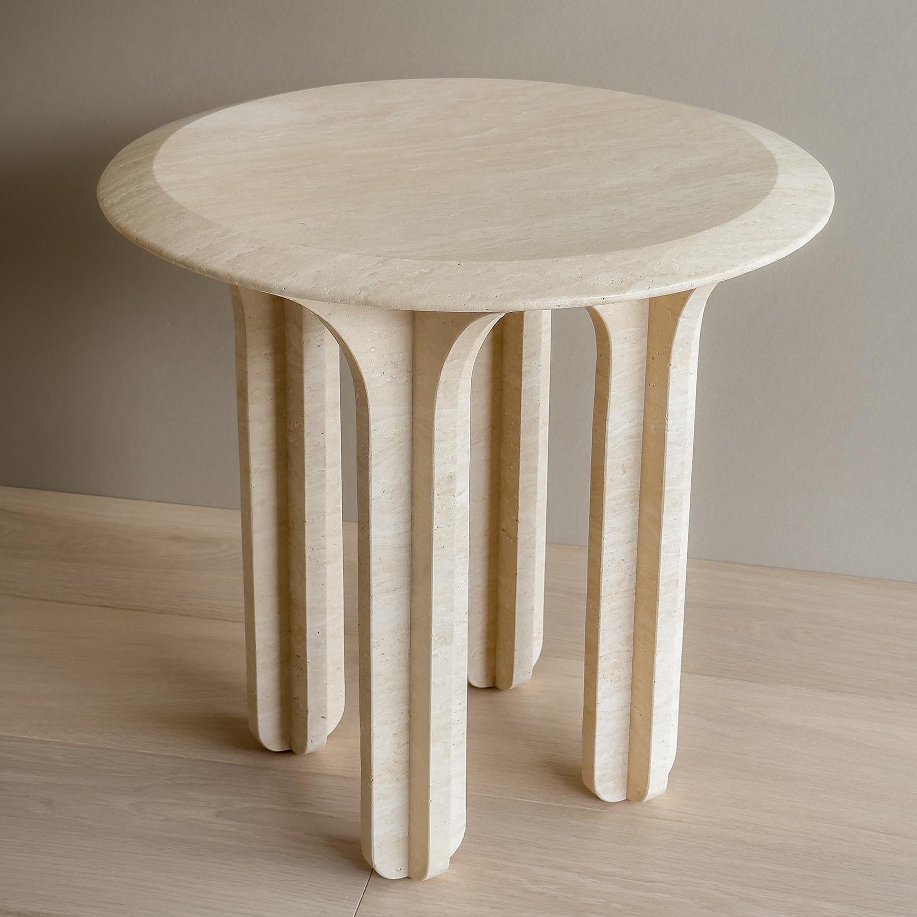 The CURVO Table is the perfect centerpiece to any contemporary home. Crafted from Italian Travertine, it has a sculptural quality that is sure to make a statement. Its carved legs were inspired by arches, giving it an elegant and timeless look. The