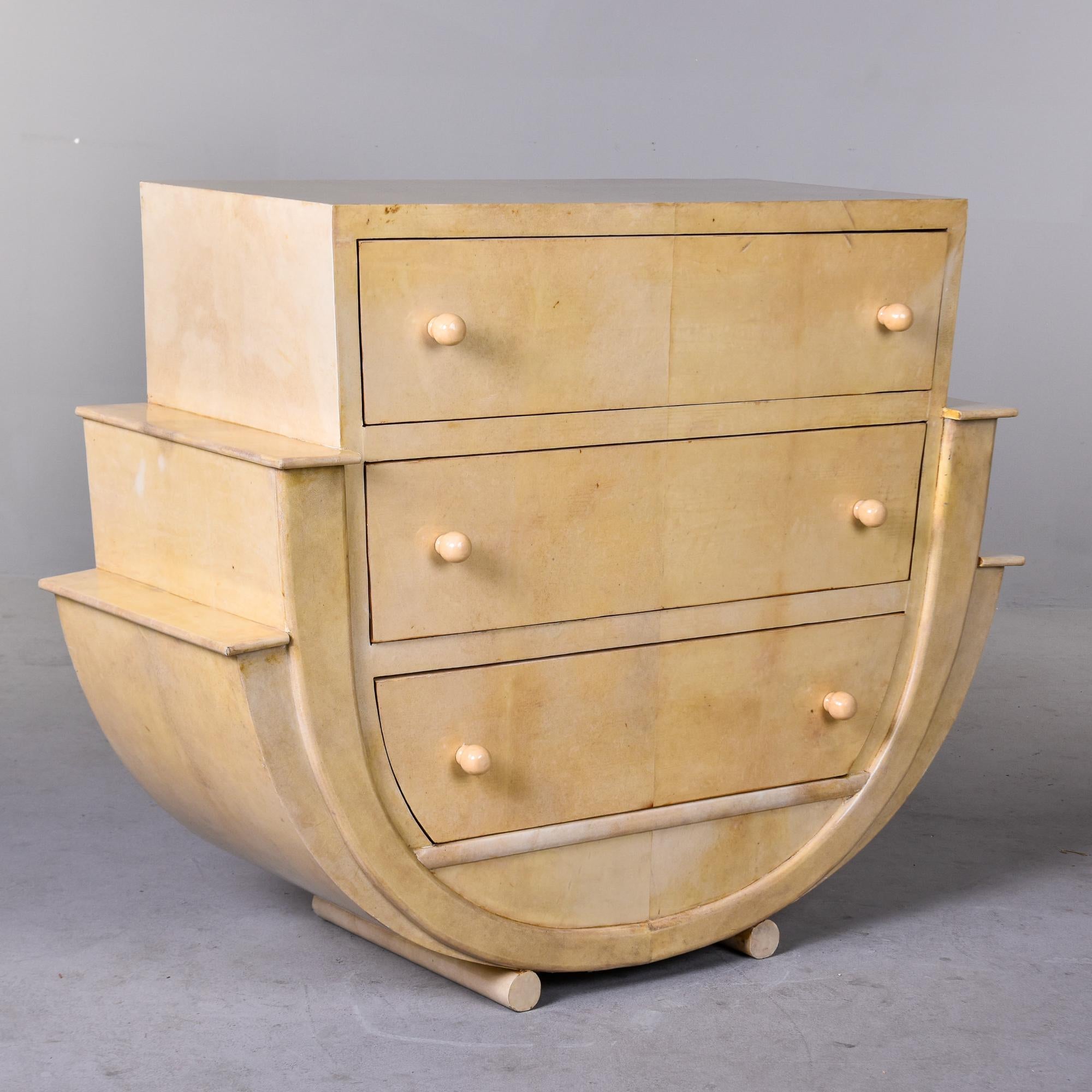Found in Italy, this circa 1980s chest has great Art Deco style and lines. Three drawer chest with a curved, stepped base on parchment-covered dowel legs. Drawers have rounded pulls. Unknown maker. Overall very good vintage condition with minor