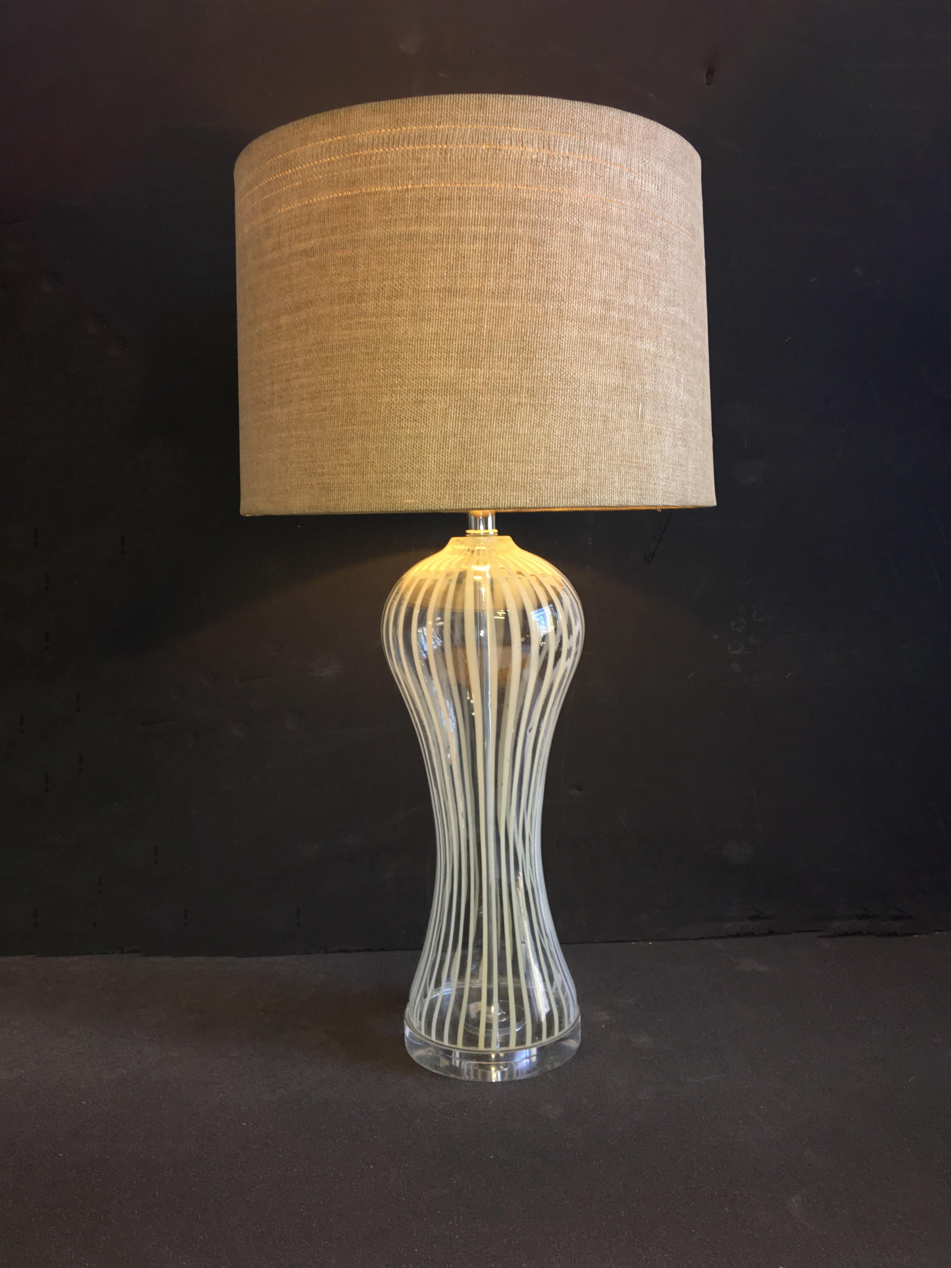 An exuberant, glass lamp fashioned into a curvy, hourglass shape and designed.
w/o lampshade: 7.5