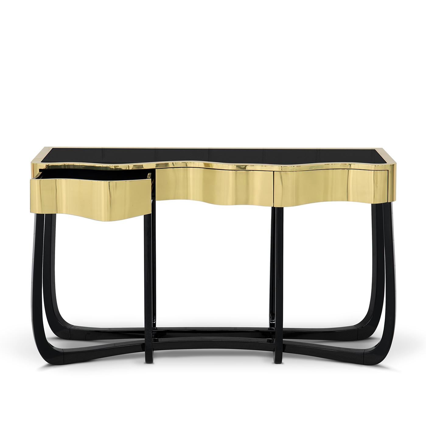 Console table curvy gold with polished brass golded finish 
top structure and with black glass flat top. With mahogany legs 
in black lacquered finish.
Also available in patinated brass top finish or copper finish,
with mahogany legs in black