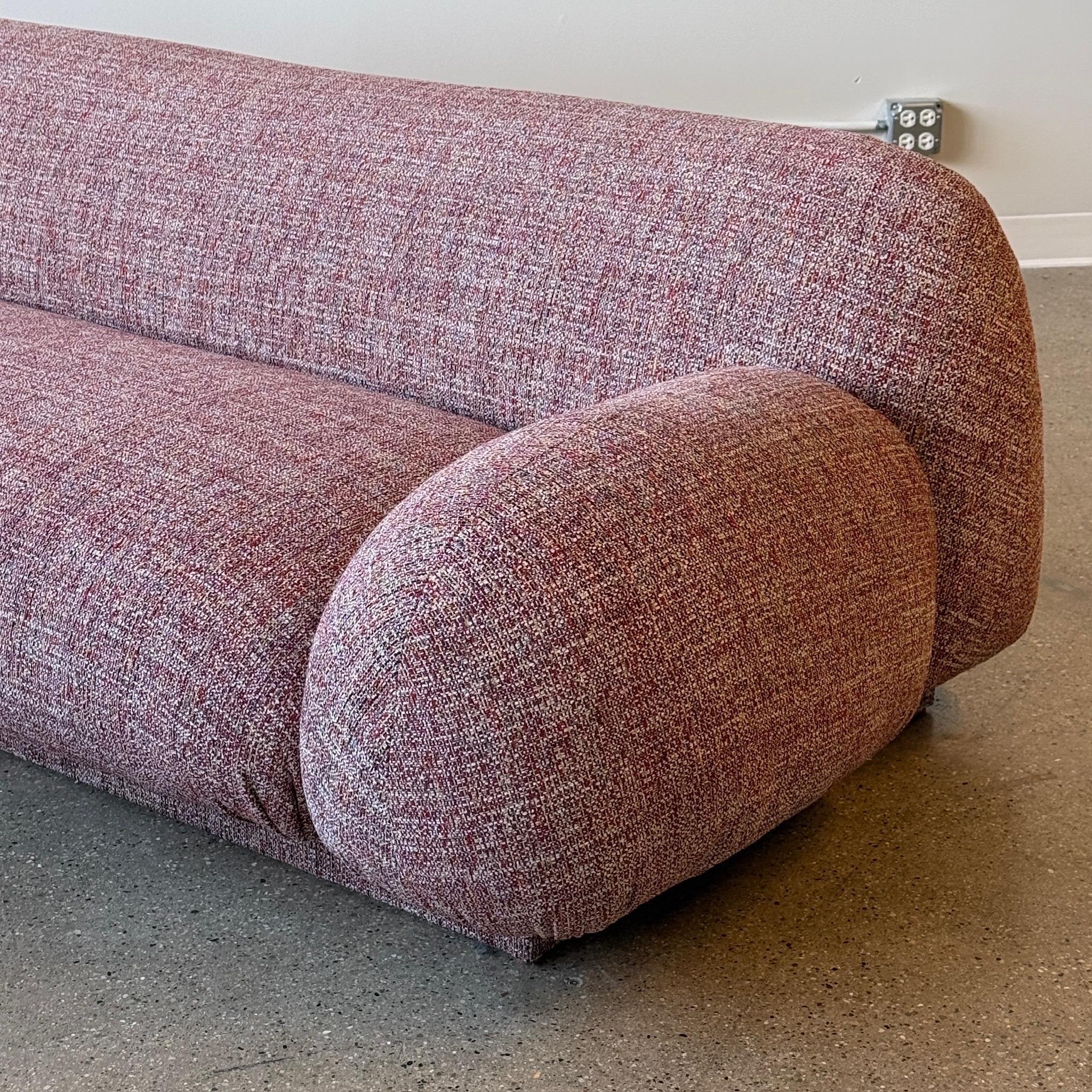 c. 1980s. Reupholstered in red/multicolor chenille fabric. Overstuffed look and cannot find designer, so assuming custom made. 

