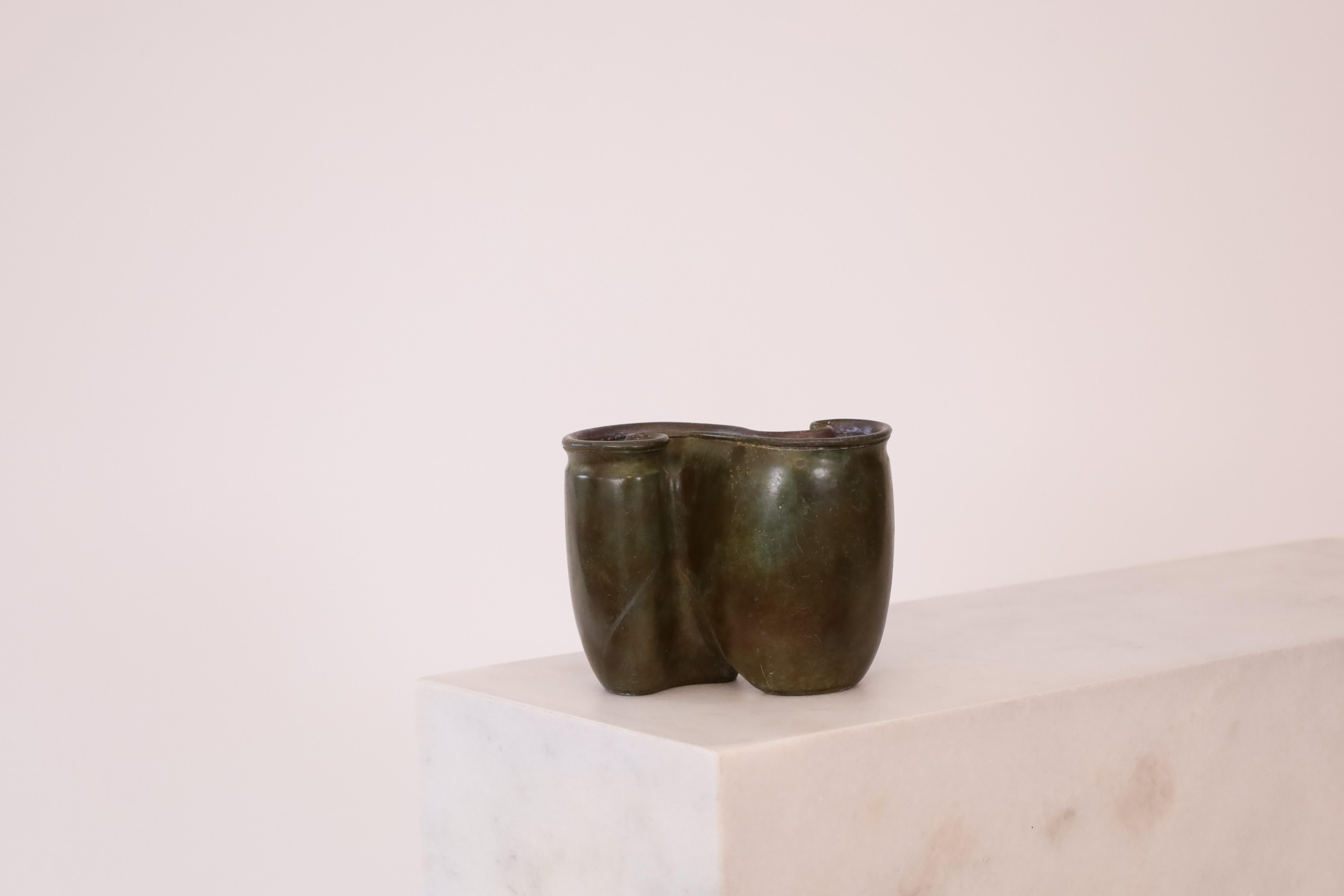 A curvy vase by designed by Just Andersen in 1938. It is very vare rare and absolutely exquisite. A substantial center piece for any beautiful space. 

* A curvy metal vase (heavy construct)
* Designer: Just Andersen
* Model: D2075 (Stamped ‘Just