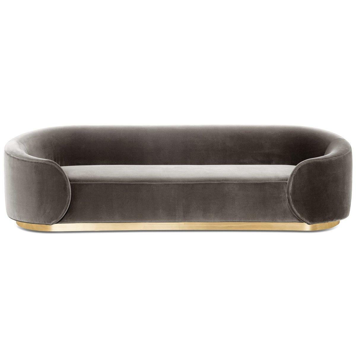 Introducing the Eden Rock sofa in velvet. Curvy wraparound arms give a unique look to this bold sofa. The solid natural lines bring serenity and calm to any space. Featuring a shiny brass toe kick and customizable velvet