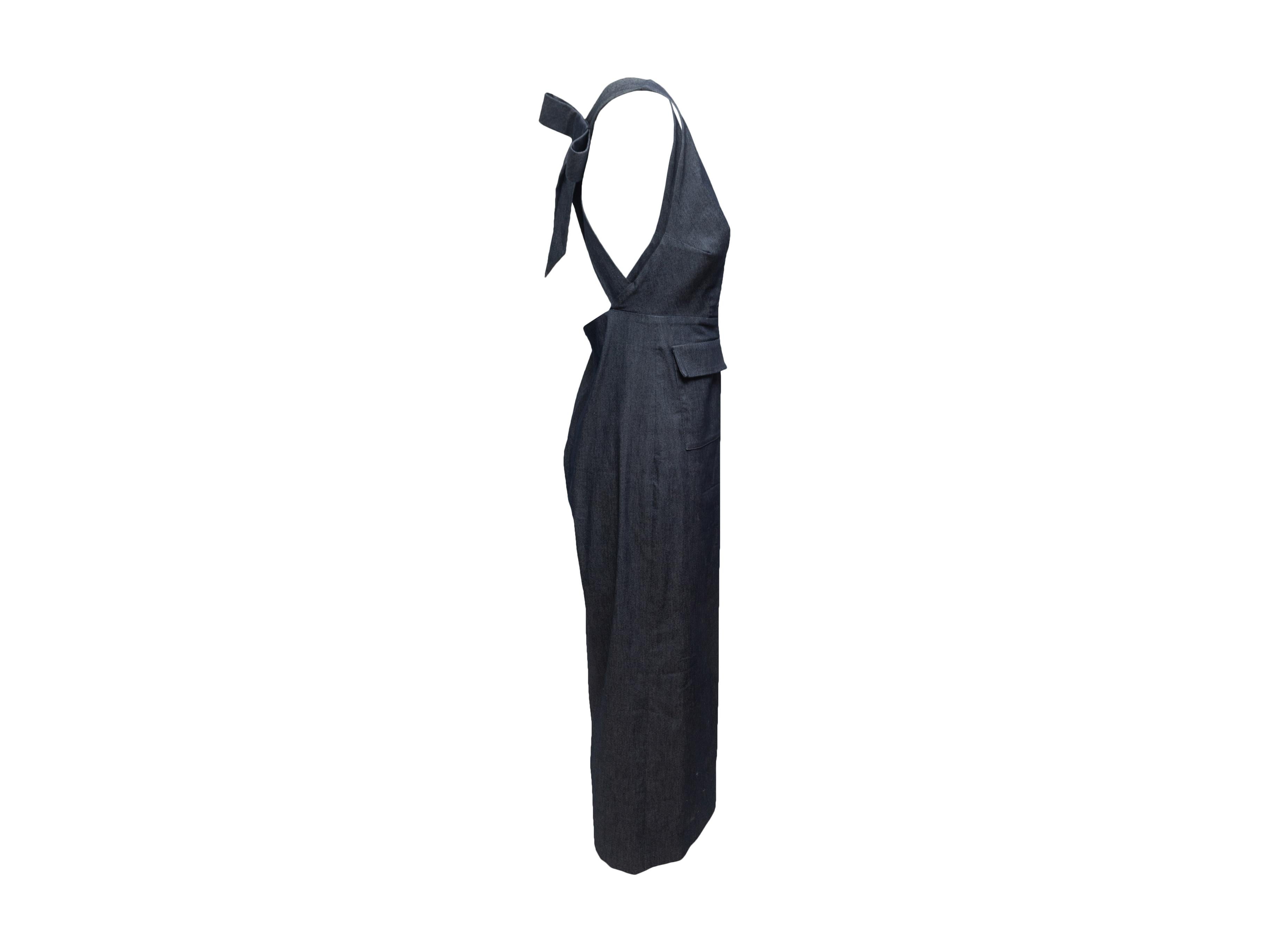 Product details: Dark blue denim Uptown overalls by Cushnie et Ochs. V-neck. Dual flap pockets at hips. Bow accent at back. Zip closure at center back. 17