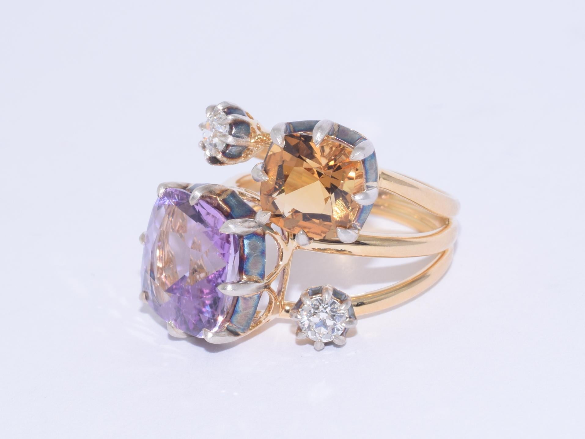 A stacked cocktail ring features a cushion amethyst weighing approximately 4.86 carats and a cushion citrine weighing approximately 1.97 carats accented with 2 old European cut diamonds totaling approximately 0.44 carats in a silver topped 18 karat