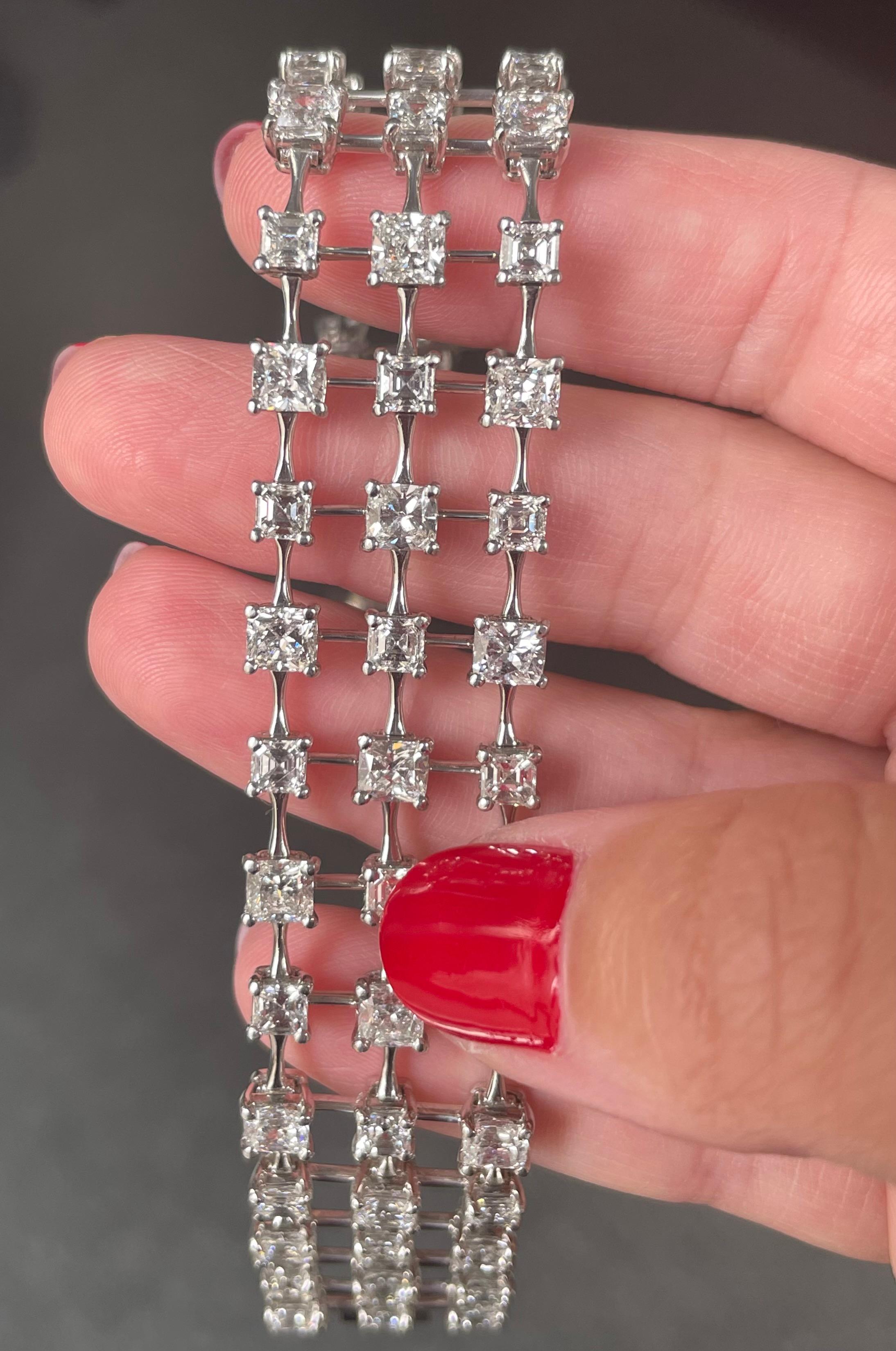 Sleek and sexy,  this three row diamond bracelet is a sophisticated addition to any jewelry collection. The delicate bars of platinum and negative space are the perfect background to emphasize the diamonds. The bracelet contains 31 cushion cut