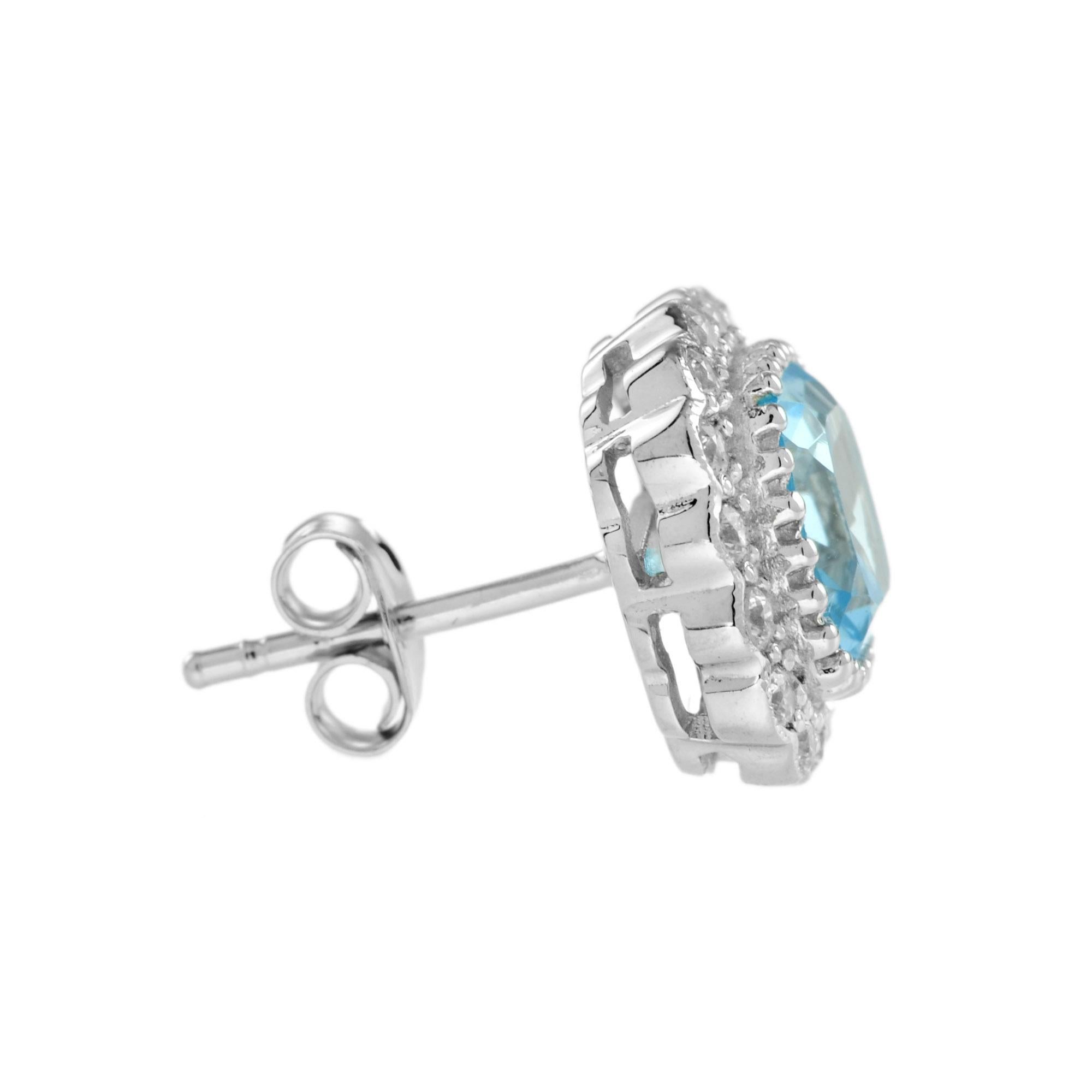 This gorgeous 14k white gold halo earrings feature a total of 3.80 carat cushion-cut blue topaz  surrounded by a halo of diamonds. An effortless upgrade to your accessary wardrobe. Wear it with our same design pendant for your perfect look.
