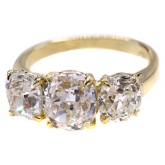 Dreisteinring mit Kissenschliff-Diamant im Brillantschliff und Diamant im alten europäischen Schliff