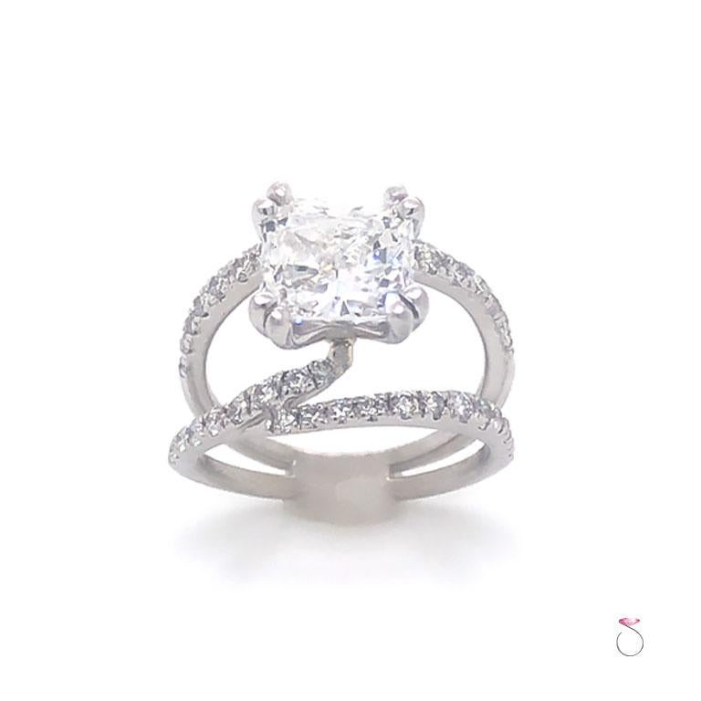 This elegant engagement ring is in 14K white gold features a 2.05 ct. cushion brilliant cut diamond, color F and clarity VS1 with GIA diamond report.  The diamond is set in four double prong head. The ring features an open double shank pave' set