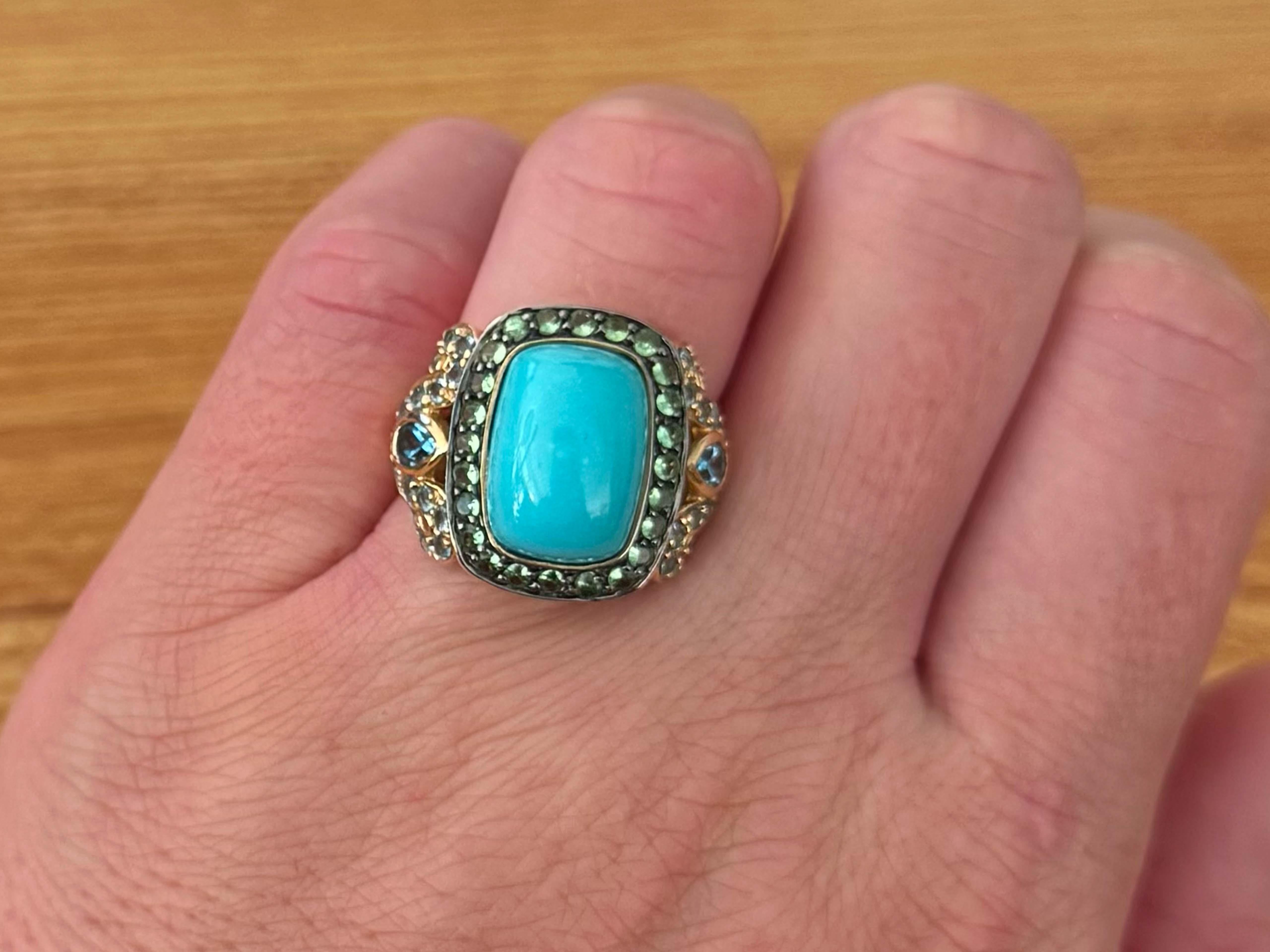 Item Specifications:



Metal: 14K Yellow Gold



Size: 7
​

Total Weight: 9.7 Grams
​
​Gemstones: Turquoise, topaz and peridot


Topaz Count: 30 round cut and 2 pear shaped, 32 blue topaz in total



Peridot Count: 24 round green