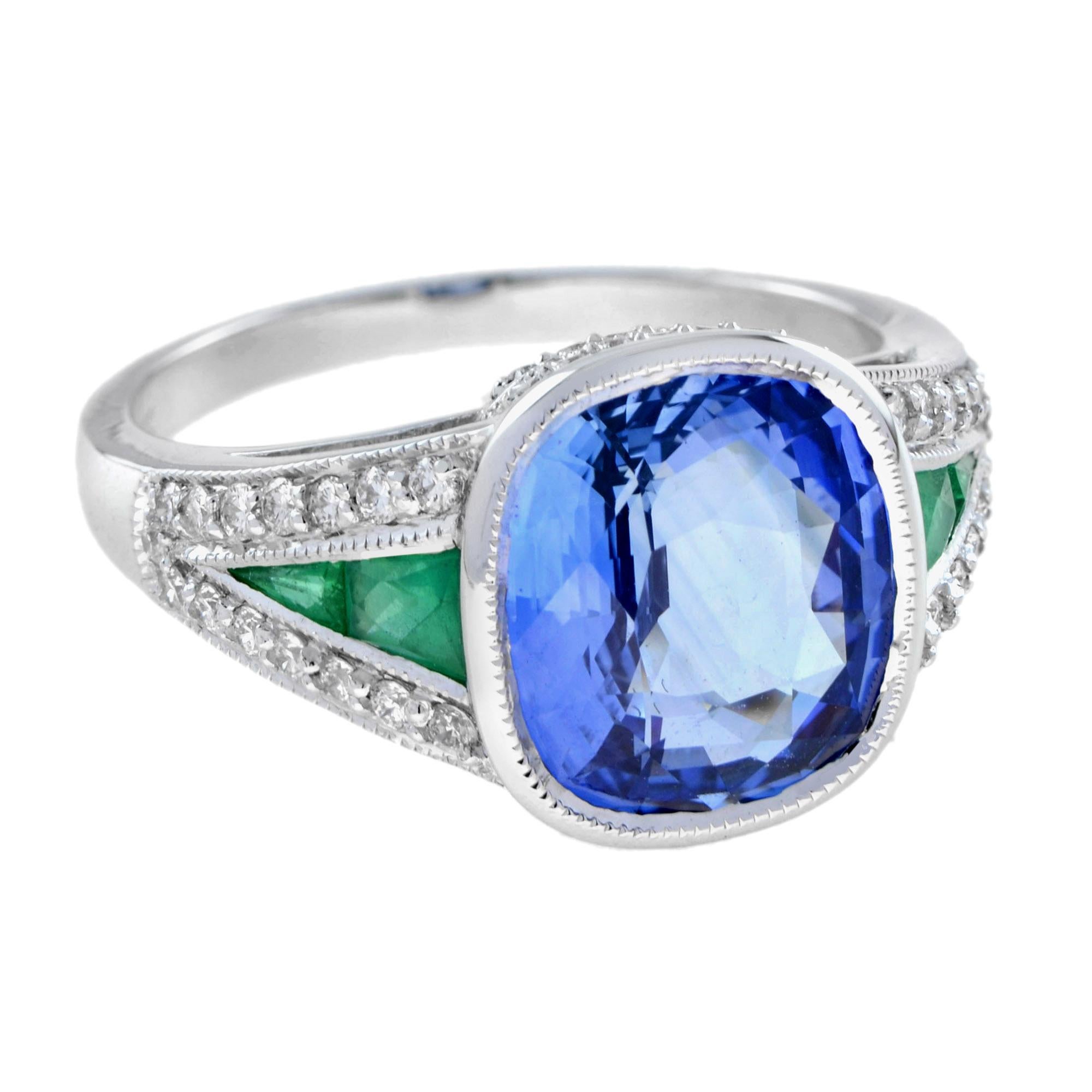 This exquisite ring is centered with 4.47 carat cushion Ceylon sapphire into bezel setting. The ring shoulders are accented with French cut emeralds and H color SI clarity diamonds. The gemstones are bordered with milgrain edging. This Art Deco
