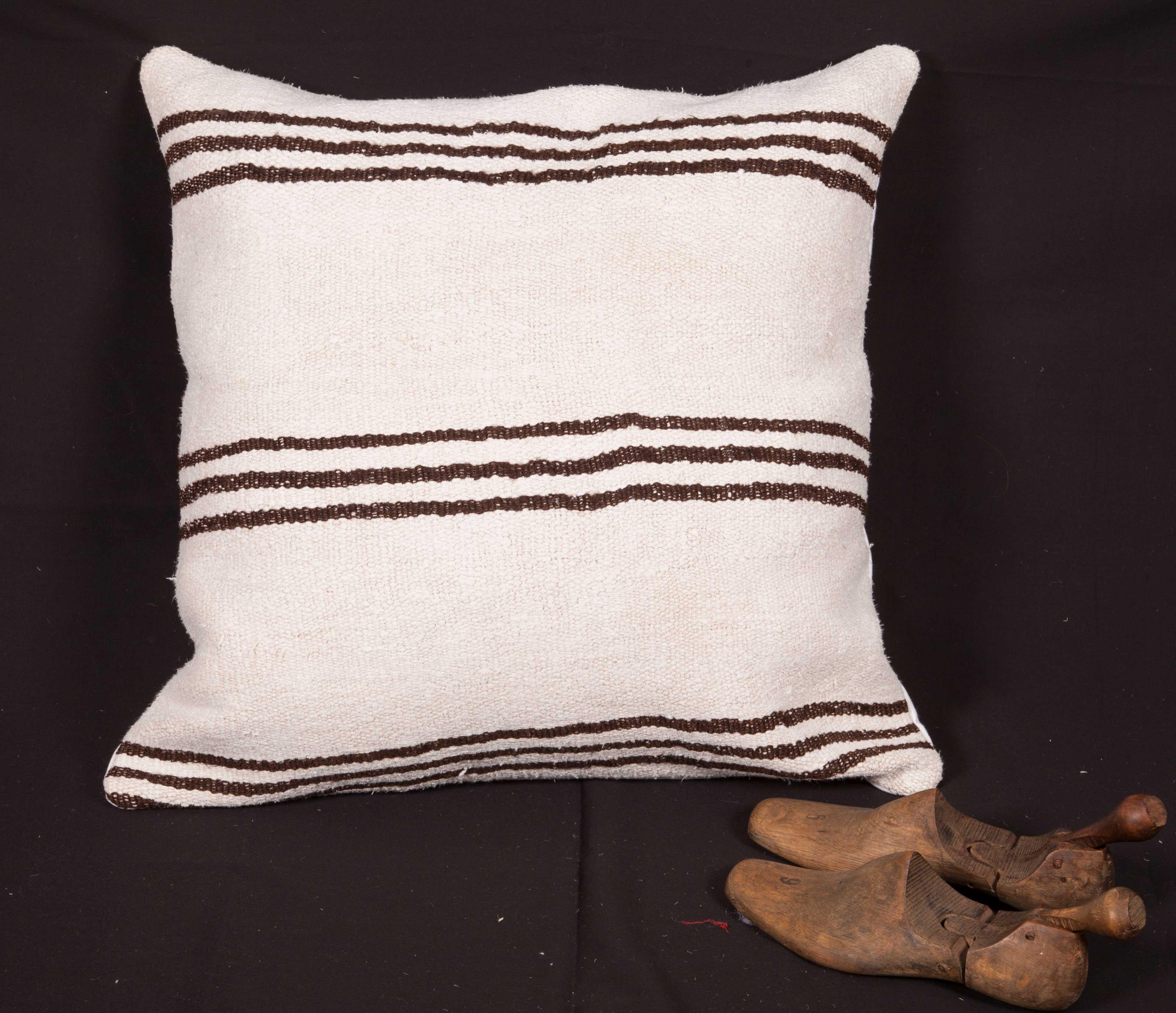 The pillow is made from a vintage Anatolian Hemp Kilim. It does not come with an insert but comes with a bag made to the size and out of cotton to accommodate the filling. The backing is made of linen. Please note filling is not provided. Since the