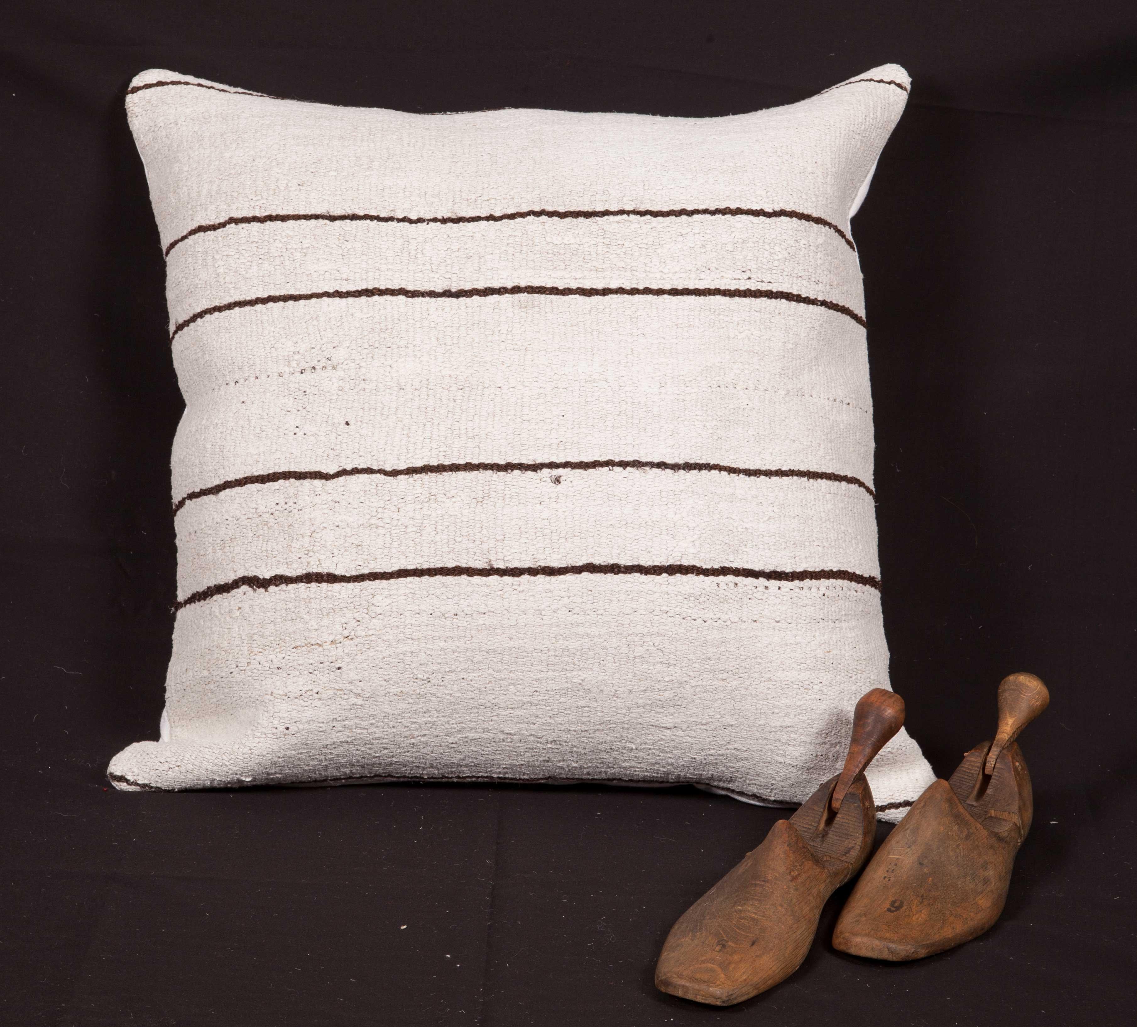 The pillow is made from a vintage Anatolian Hemp kilim. It does not come with an insert but comes with a bag made to the size and out of cotton to accommodate the filling. The backing is made of linen. Please note filling is not provided. Since the