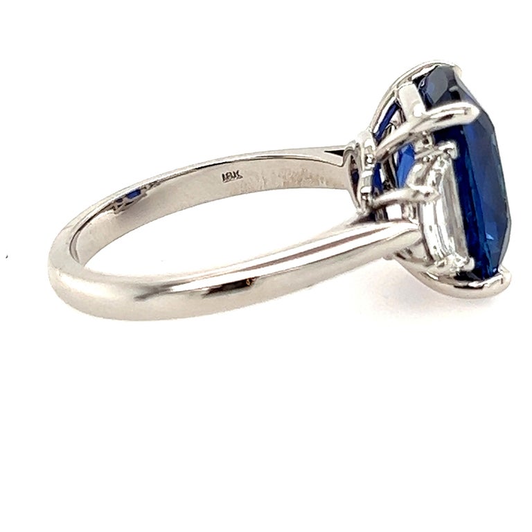 Here is a truly magnificent ring that is sure to take your breath away. This stunning piece features a mesmerizing 5.40-carat blue sapphire that is set in an elegant 18k white gold mounting. The sapphire's rich, medium-blue color is simply