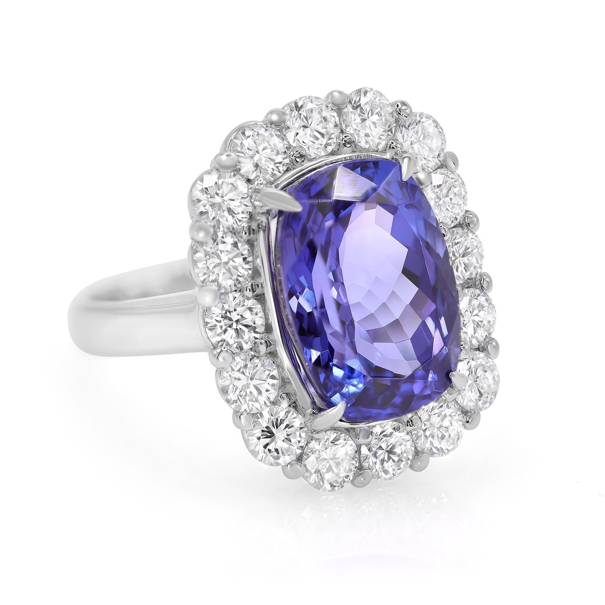 This stunning cocktail ring features top quality natural purple blue cushion cut Tanzanite which is accented with fine round cut diamonds mounted in platinum. The gemstone is rich in color and saturation that glistens from the center. The total