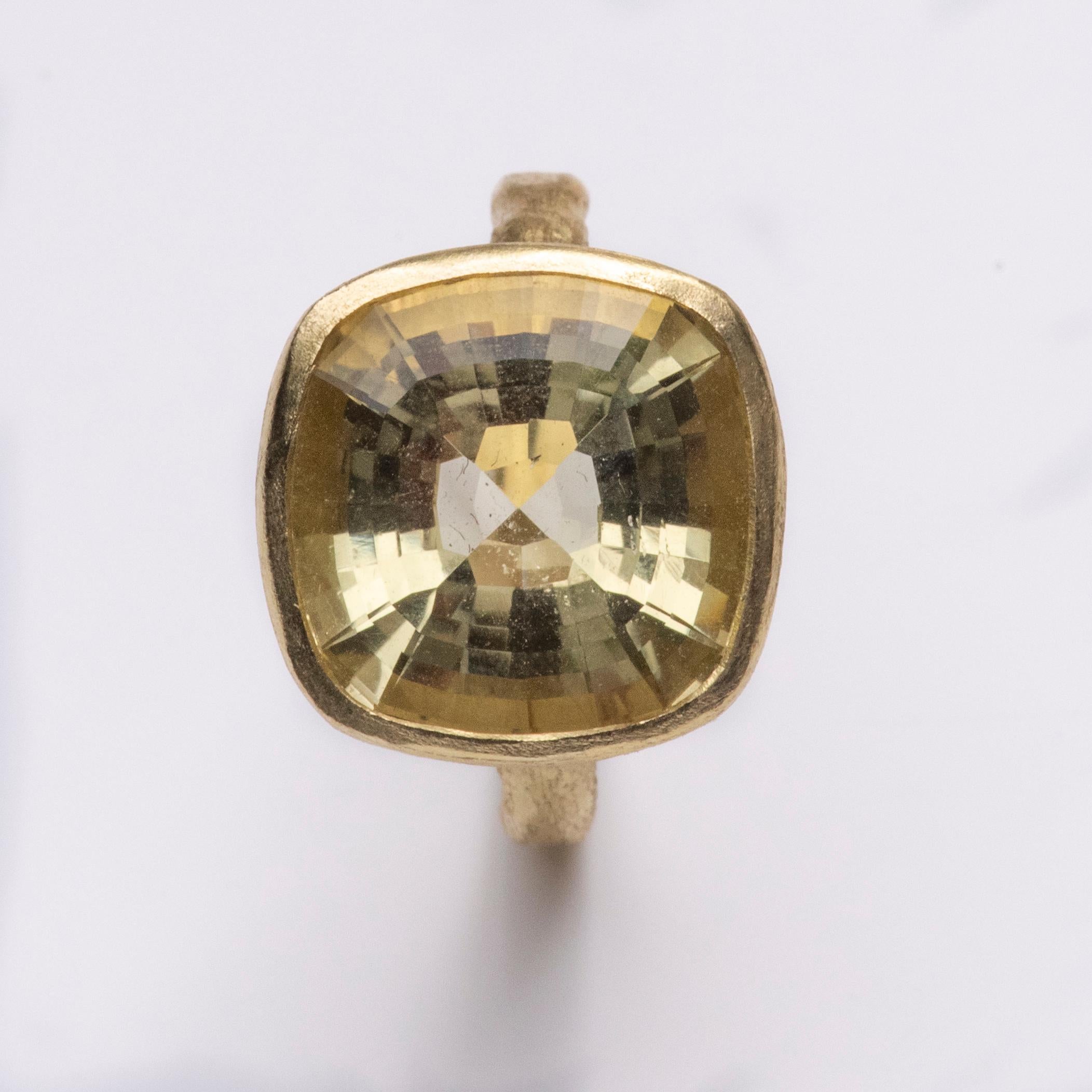 18k yellow gold handmade organic texture ring with stunning step-faceted cushion cut Lemon Quartz. At 9.27 carats this a fresh and exciting statement piece that can be worn on its own or in a stack.

Disa is known for her use of colourful and