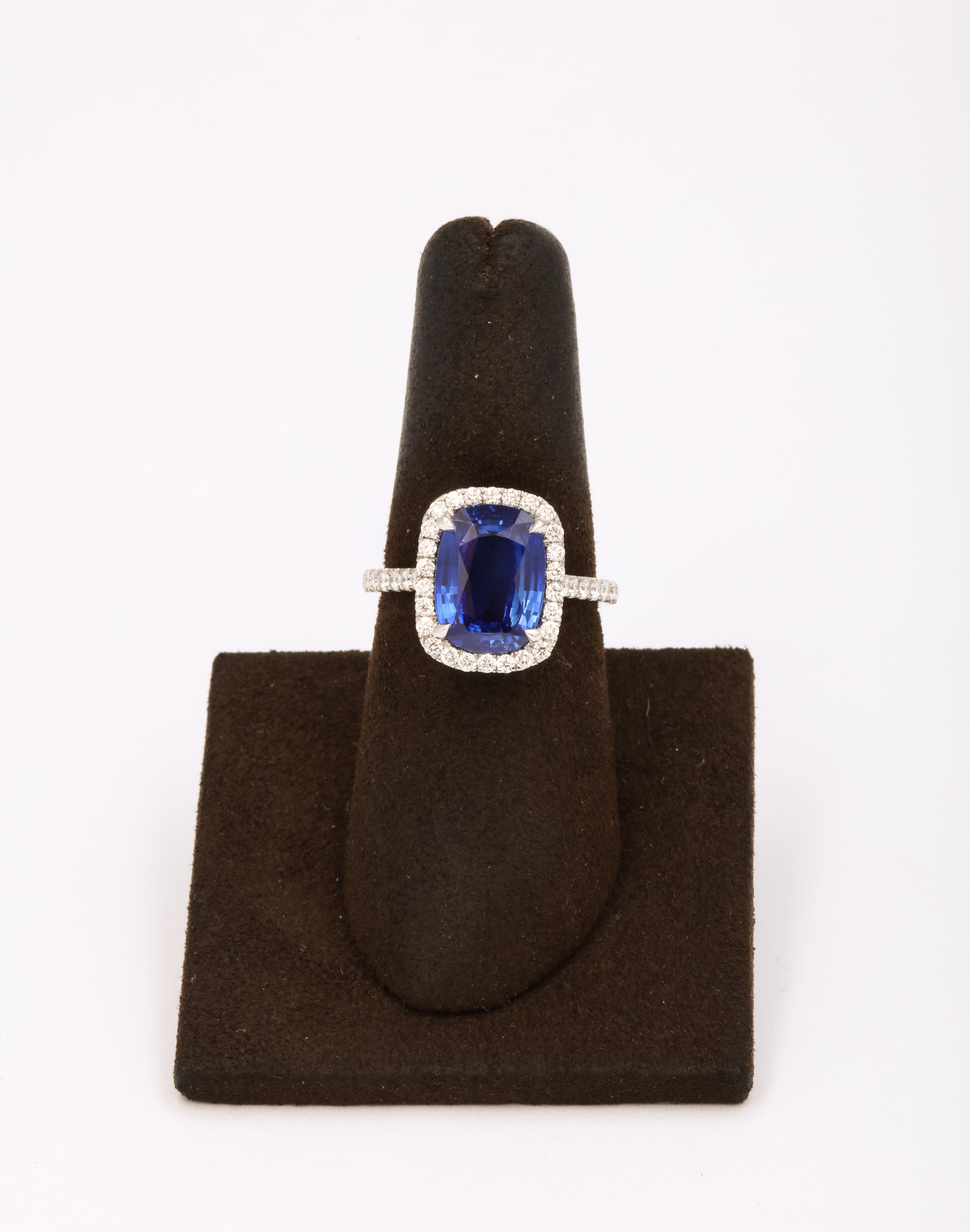 
A fabulous stone in the most sought after elongated cushion shape! 

4.71 carat Ceylon, Cornflower Blue Sapphire 

.78 carats of white diamonds 

Set in a custom made platinum diamond halo mounting. 

Currently a size 6.5 this ring can easily be