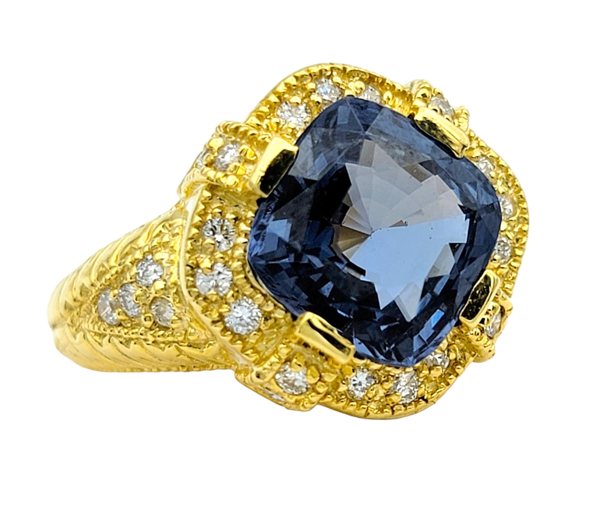 Ring Size: 5.75

Exuding elegance and sophistication, this glorious ring showcases a stunning blue cushion spinel embraced by a sparkling halo of diamonds, all set in luxurious 18 karat yellow gold. The vivid hue of the spinel captivates the eye,