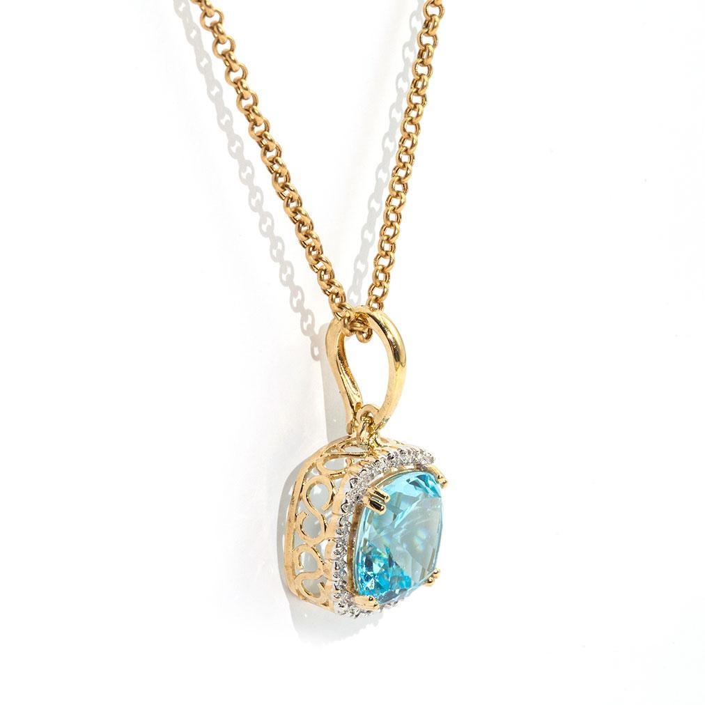 Forged in 9 carat yellow gold is this gorgeous vintage inspired pendant featuring a bright cushion cut  natural blue topaz surrounded by a halo border of carefully set diamonds. We have named this wondrous piece the Kata Pendant. The Kata Pendant is