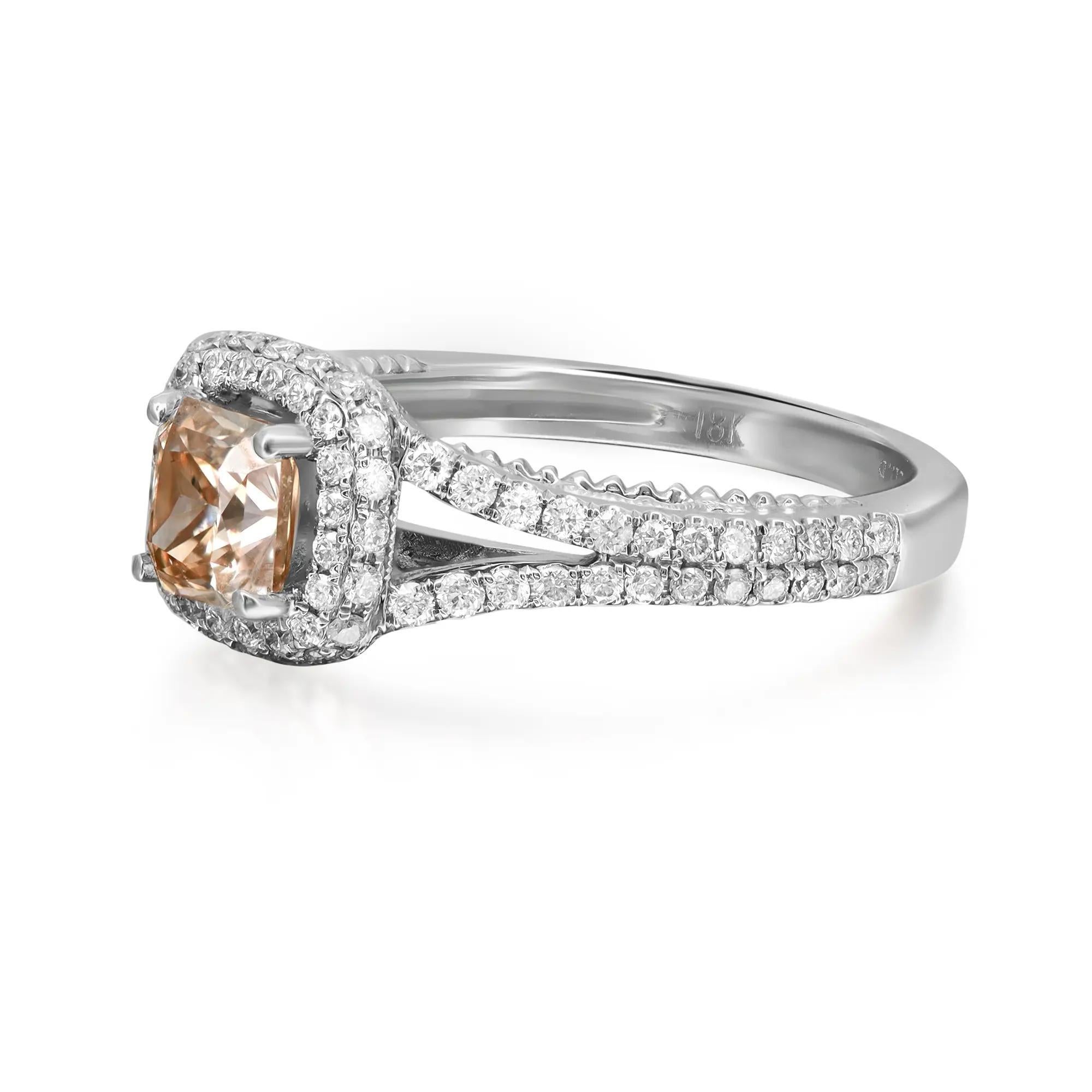 This stunning engagement ring comes with a flashy statement look. A must have in your jewelry collection. The ring is crafted in 18K white gold. Showcases a prong set cushion cut brown diamond in the center weighing 1.00 carat, accented with round
