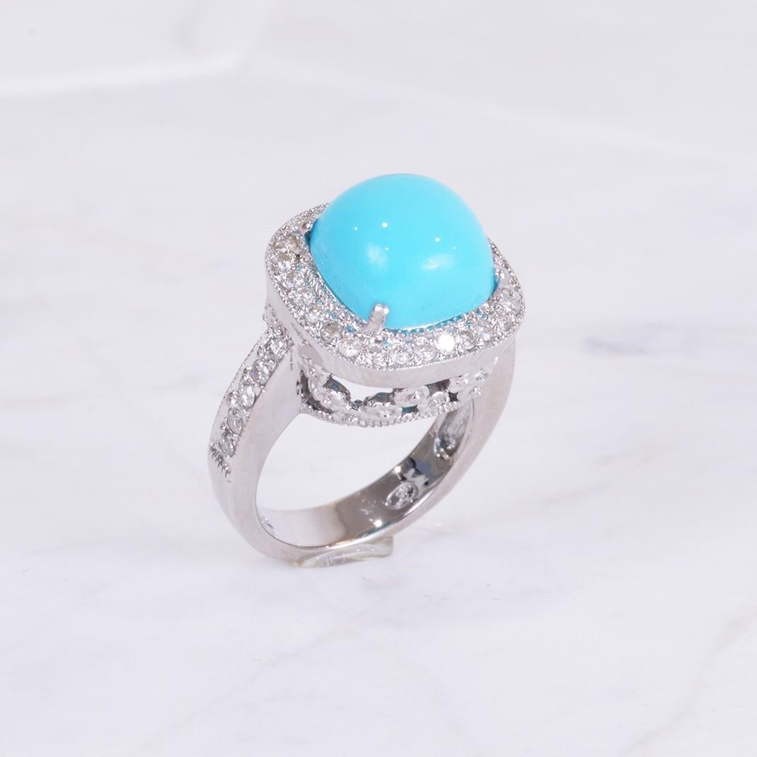 Such a truly eye catching ring! This ring has a beautiful cabochon cut sleeping beauty turquoise in the center surrounded by .50 carats of diamonds, all hand set in 14k white gold. Ring size 4.