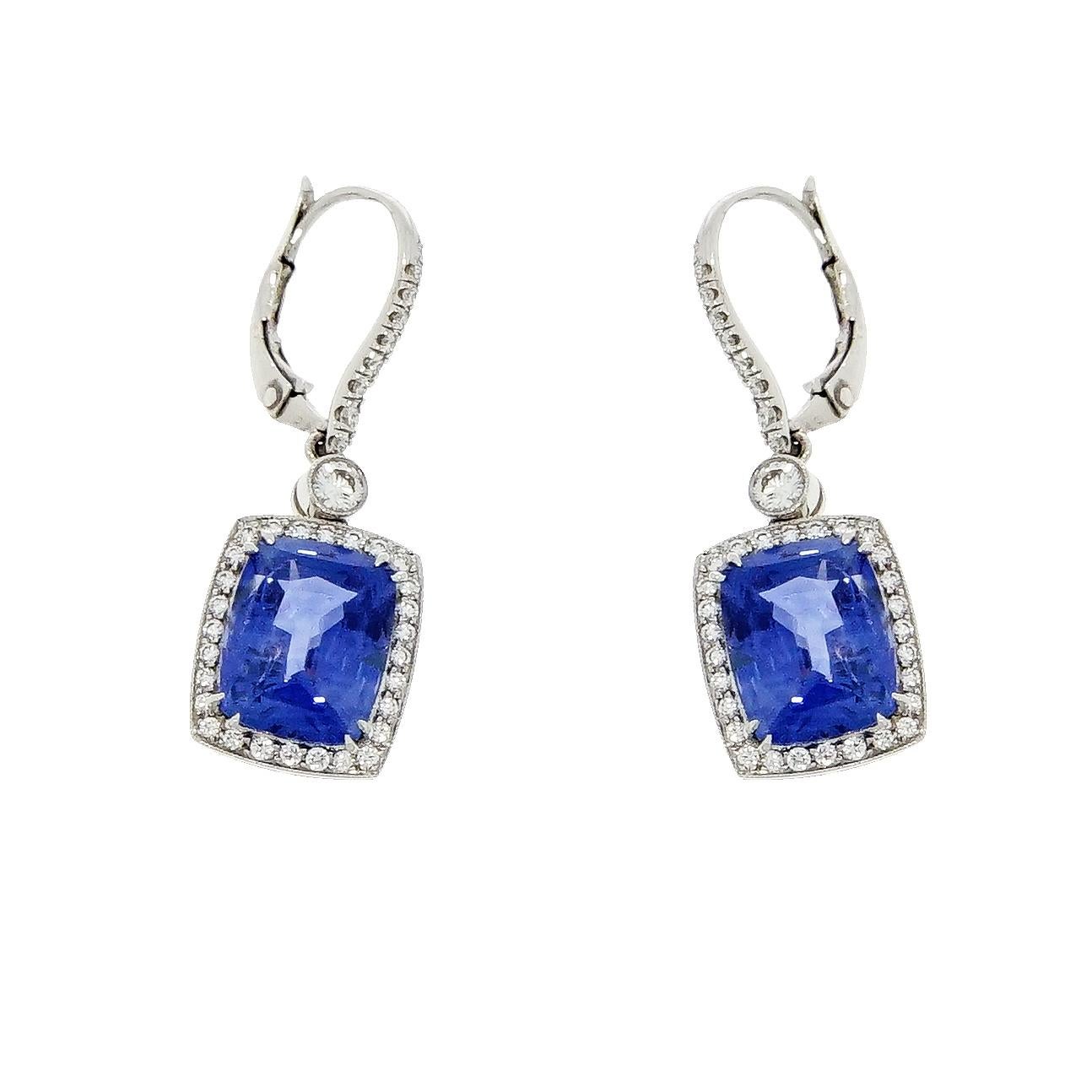 Stunning drop earrings consisting of 2 cushion cut unheated Ceylon sapphires having a total weight of 10.69 carats (5.01carat and 5.68 carat respectively), surrounded by a single row of 56 round brilliant cut diamond halo, weighing 1.56 carats.