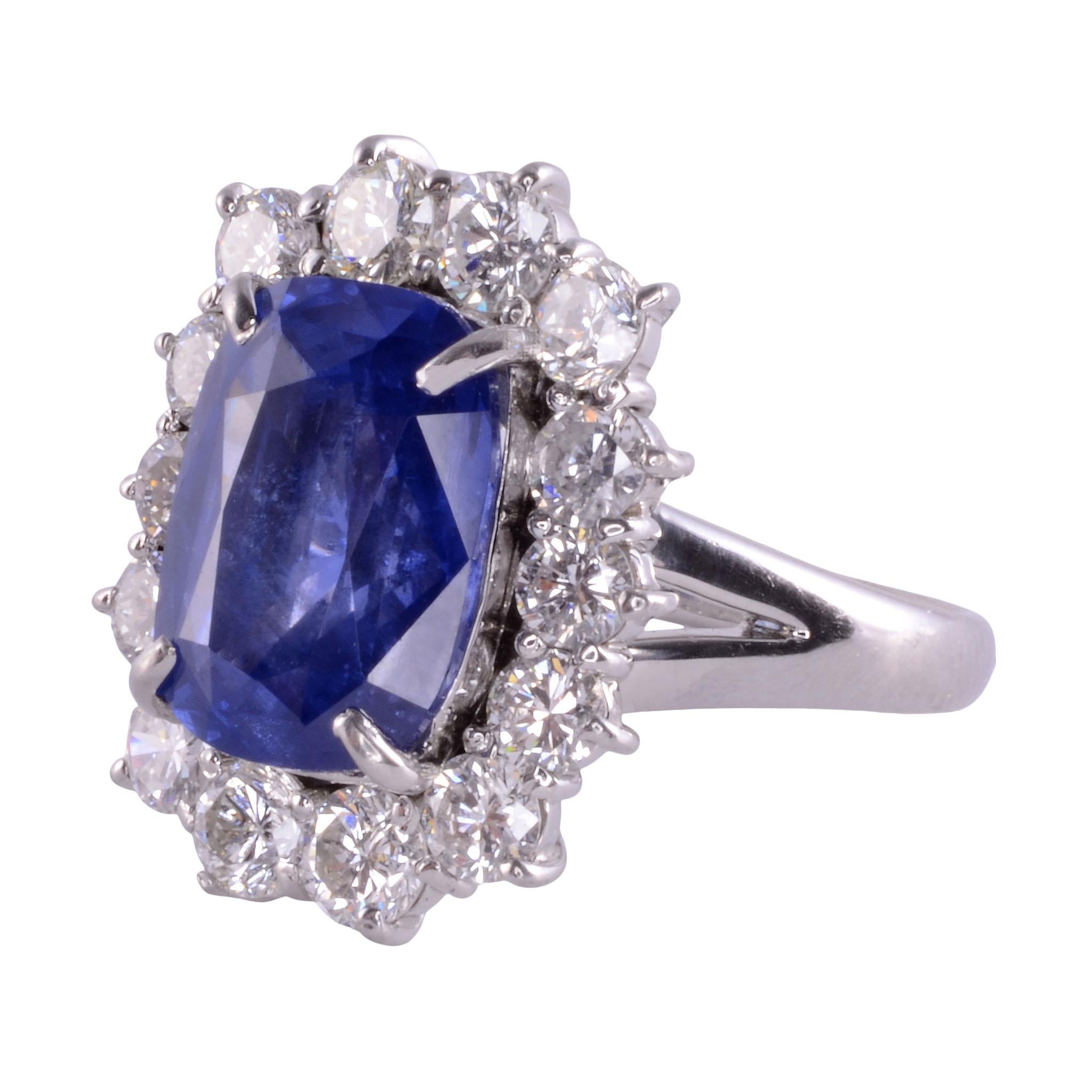 Estate cushion cut Ceylon sapphire & diamond ring. This platinum custom made ring features a 6.83 carat cushion cut sapphire center with fine medium blue Ceylon color. The sapphire is accented with 2.01 carat total weight of round brilliant cut