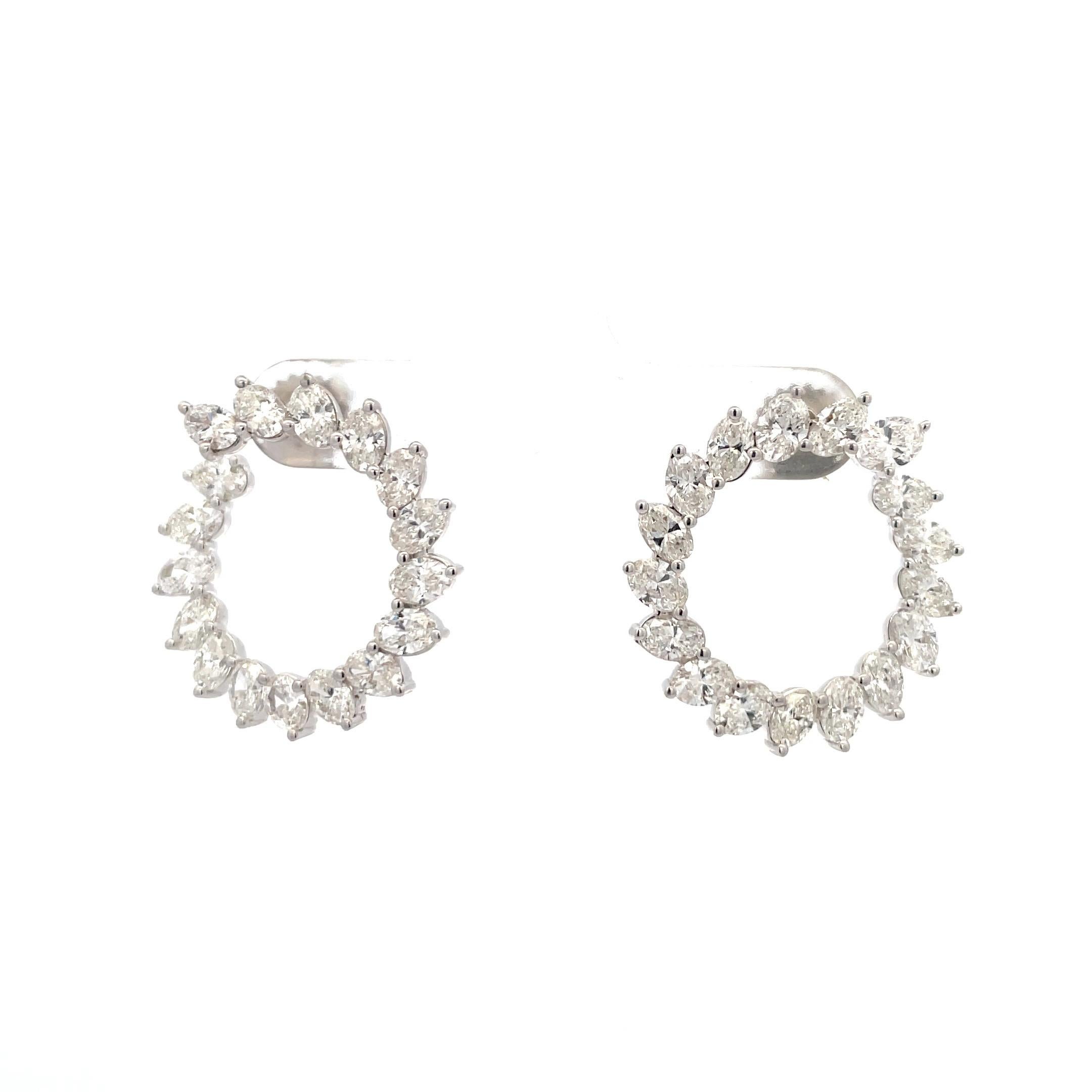Crescent motif diamond hoop earrings featuring 34 Cushion cuts weighing 6.68 carats, in 18 karat white gold.
Average 0.20 Carats
Color G-H
Clarity VS1-VS2