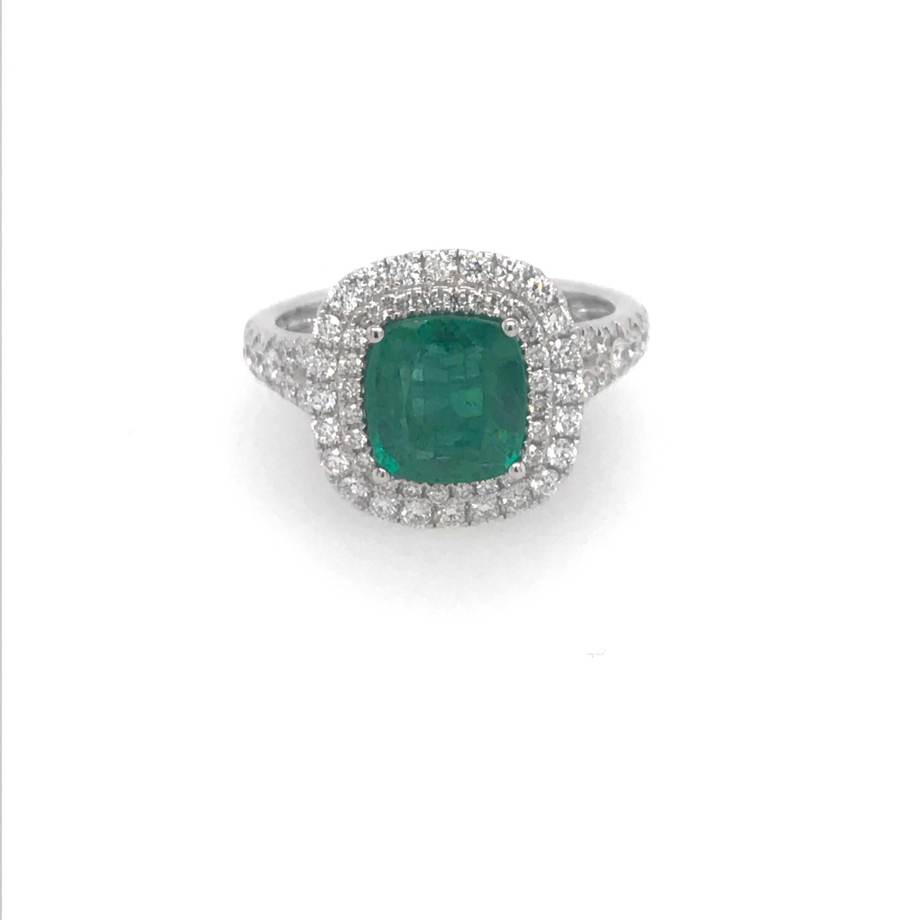 18K White gold ring featuring one cushion cut green emerald weighing 1.99 carats flanked with a double halo and split shank weighing 0.65 carats.
Color G-H
Clarity SI

A beautiful ring!!!