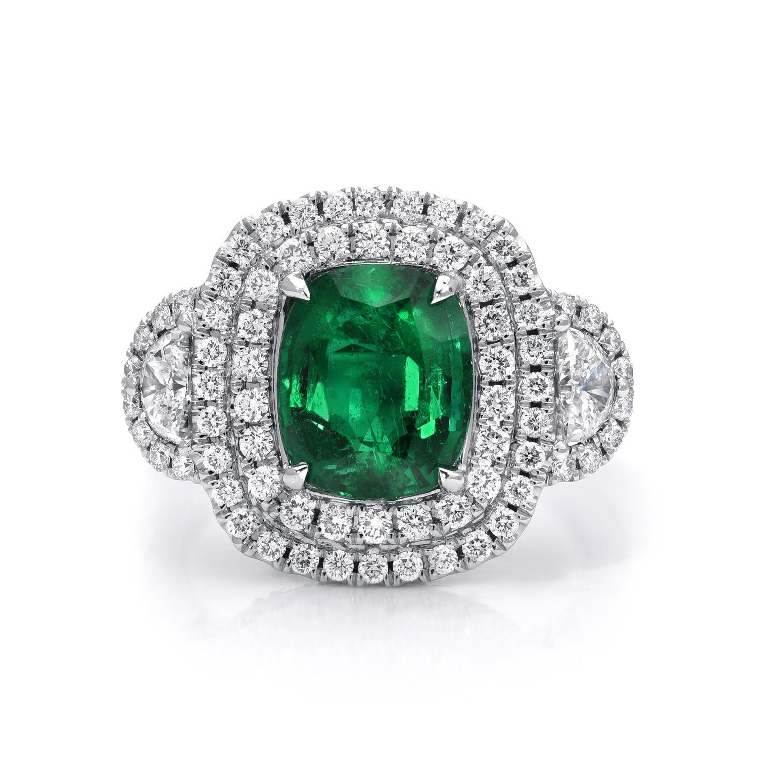 Emerald ring hand set with a cushion cut weighing 2.77 carats, adorned by a total of 1.43 carats of micro pave diamonds. This Emerald engagement ring or Emerald cocktail ring is crafted in 18K white gold.
Size 6.5. Re-sizing is complimentary upon