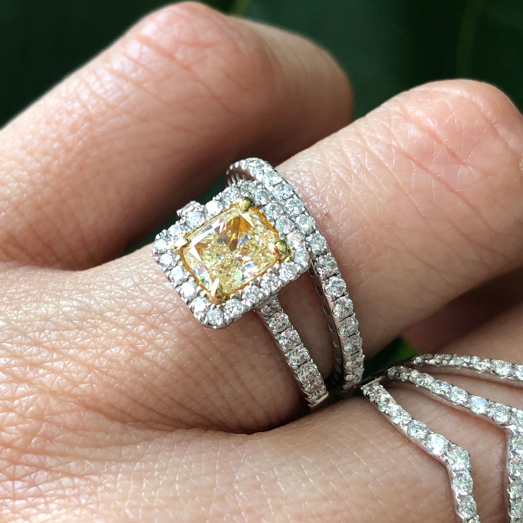 18K white gold, fancy intense yellow diamond engagement ring with diamond halo.

Features
18k white gold
1.20 carat, cushion cut, fancy intense yellow diamond.
.48 carat total weight in white diamonds on the band and halo
Ring size 6.5. Can be