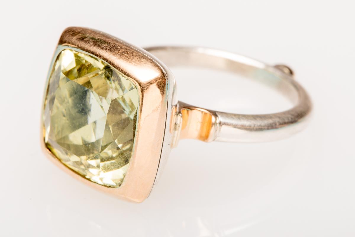 Classically styled cushion-cut green aquamarine bordered in a weighted 18K gold (this is not plated) and a sterling silver band with additional gold accents.  Ring size is 6.75-7.