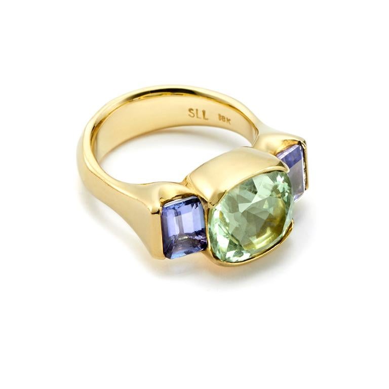 The combination of this Cushion Cut Green Beryl (5.19 Carat), set off by Emerald Cut Tanzanites (4.44 Carat), makes a wonderfully feminine and striking ring.

Dimensions of Beryl: 12.94mm x 12.23mm
Dimensions of Tanzanite: 5.61mm x 8.09mm
Dimensions