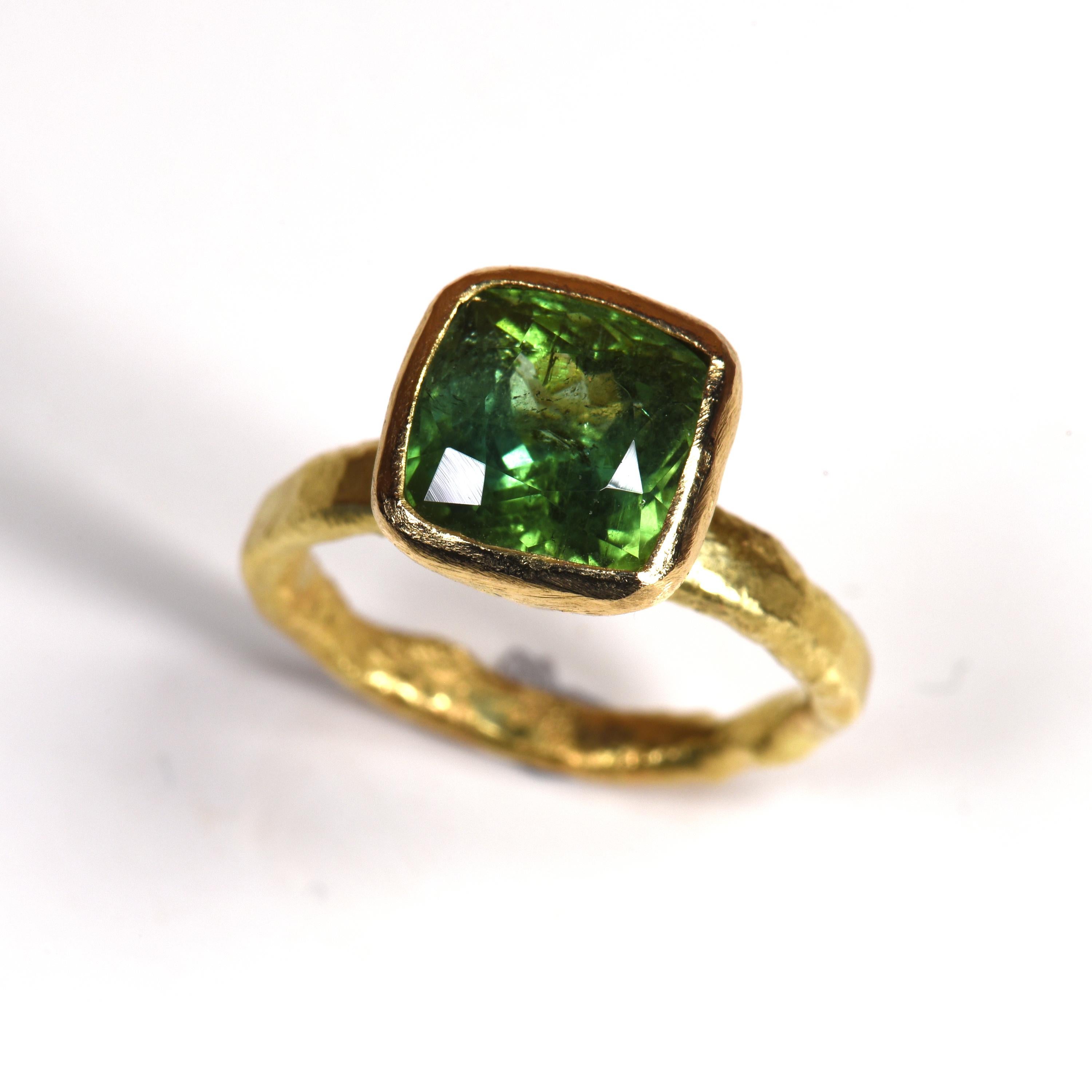 18k yellow gold melted using Disa Allsopp's signature reticulation and hammering techniques. A cushion cut Green tourmaline four carats in size is set in to a tapered rubover setting, framing the stunning colour of this Tourmaline.

Disa Allsopp is