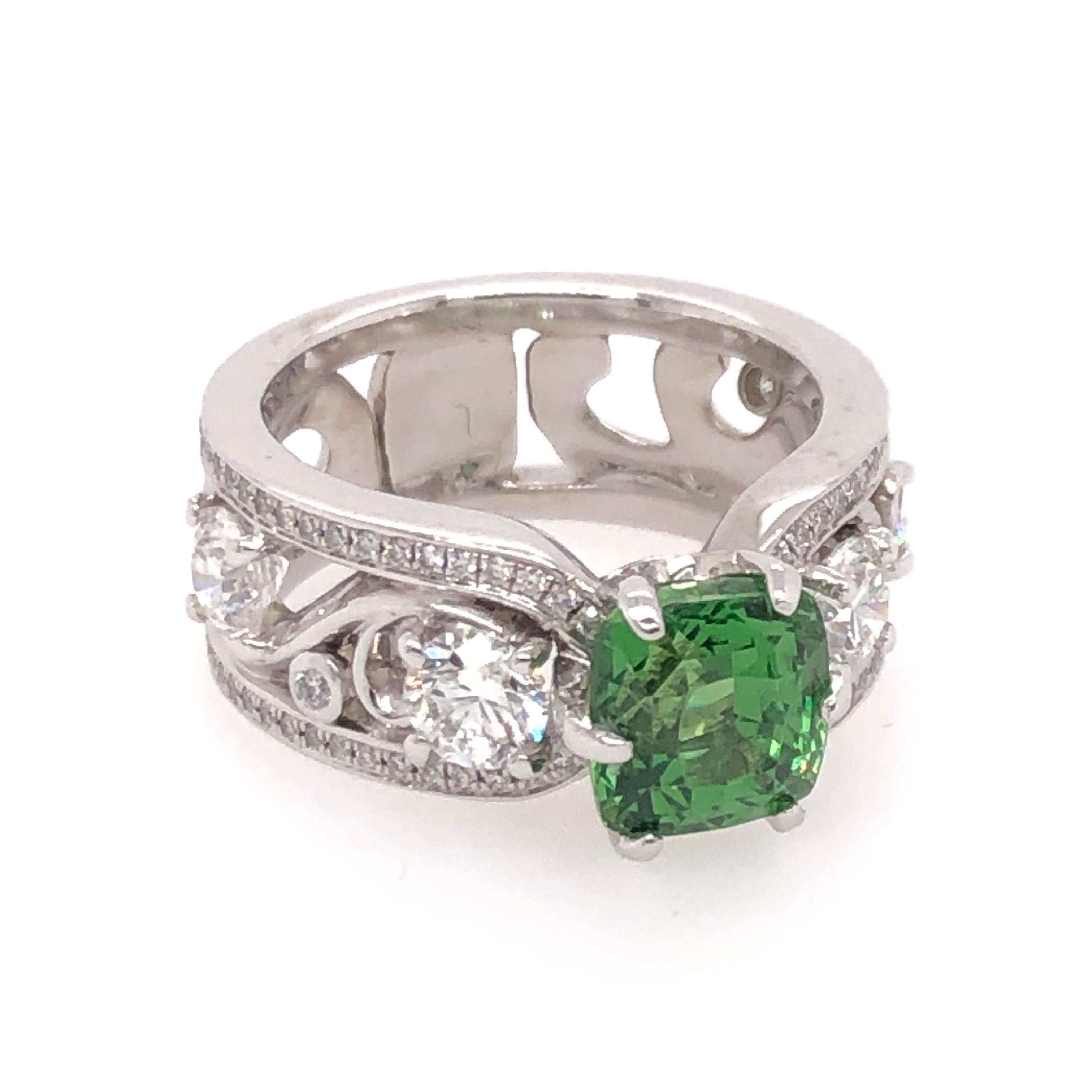 This radiant cushion cut 2.52CT green tsavorite crowns its floral motif 18K white gold setting. A total of 1.65 CTS of round cut diamonds brighten the ring with the right amount of sparkle to accent the freshness of the green tsavorite.  

Size: 5
