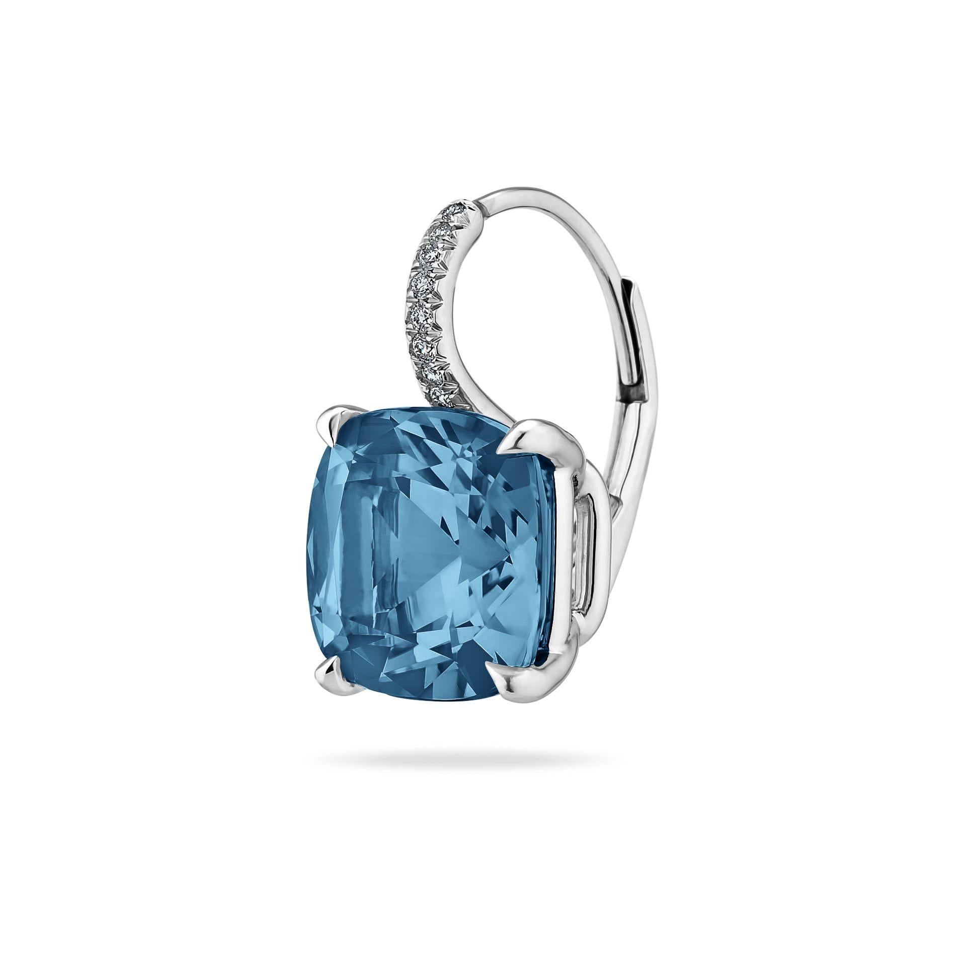 Reminiscent of calm warm waters, these medium size deep vivid blue topaz cushion cut gems, weighing a total of 9.00 carats, hang seductively from platinum diamond set wires.  Total diamond weight. .06 carats.  Lever backs.  5/8