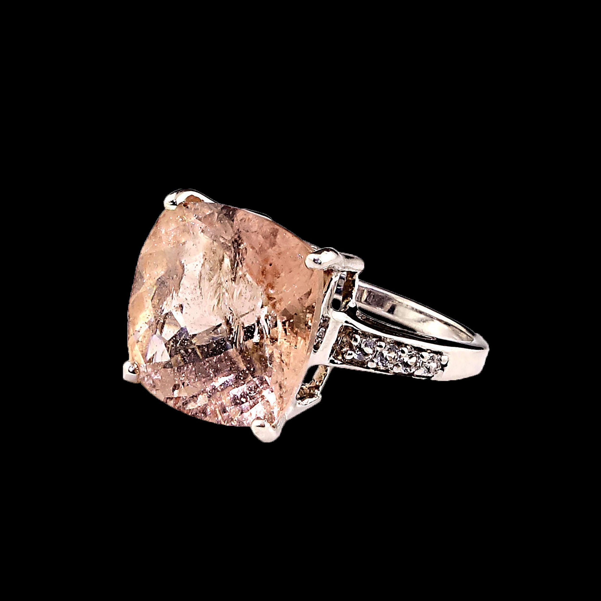 Lovely dinner ring of 8.95 carat cushion cut Morganite in Sterling Silver setting.  This Morganite is peachy in tone and features a checkerboard tabletop.  This gemstone has all the inclusions typical of the beryl family and in many cases these