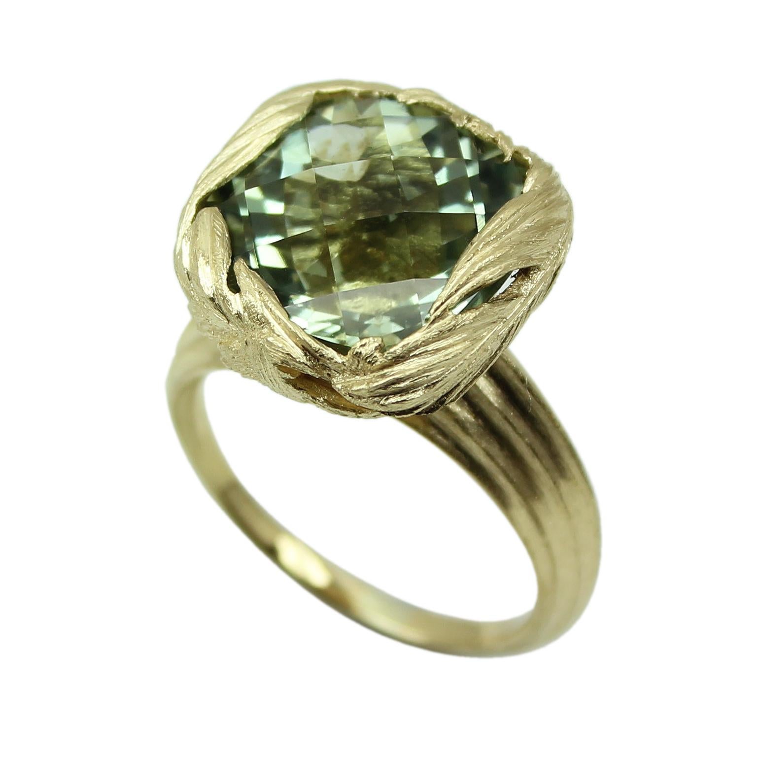 Prasiolite Cushion Cut stone set with a wrap of hand carved feathers, mounted to a grooved tapered ring shank. William Cheshire wanted to create a large but delicately made ring with an organic feel. The gentle feathers create the setting as they