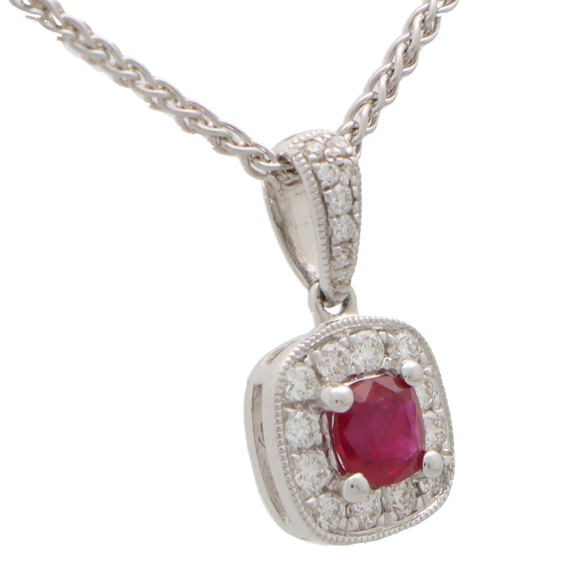 A beautiful cushion cut ruby and diamond cluster pendant set in 18k white gold.

The pendant is centrally set with a beautiful coloured red cushion cut ruby which is surrounded by 12 sparkly round brilliant cut diamonds. The pendant hangs from a