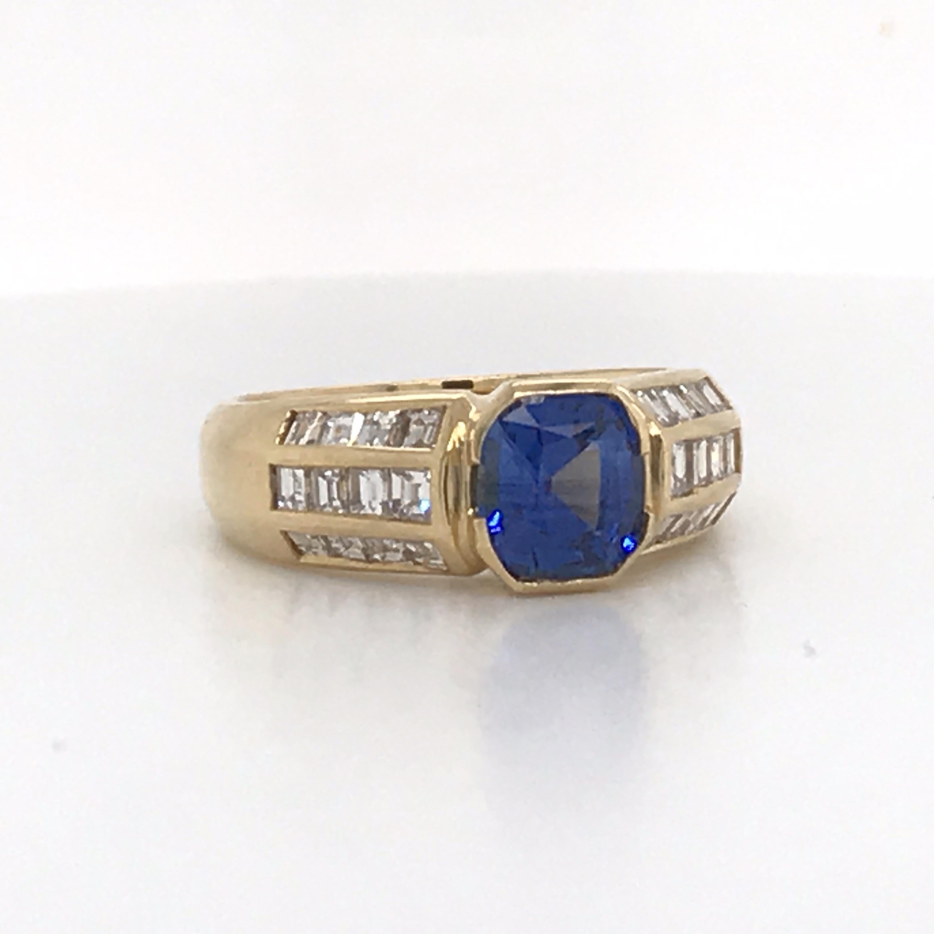 18K Yellow gold ring featuring one cushion cut sapphire weighing 1.62 carats flanked with three rows of diamonds weighing approximately 1 carat.  
Sapphire with heat
Beautiful color!

Size 7.25, sizeable 
