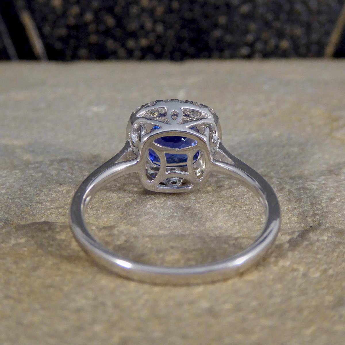 Cushion Cut Tanzanite and Diamond Cluster Ring in White Gold In Excellent Condition For Sale In Yorkshire, West Yorkshire