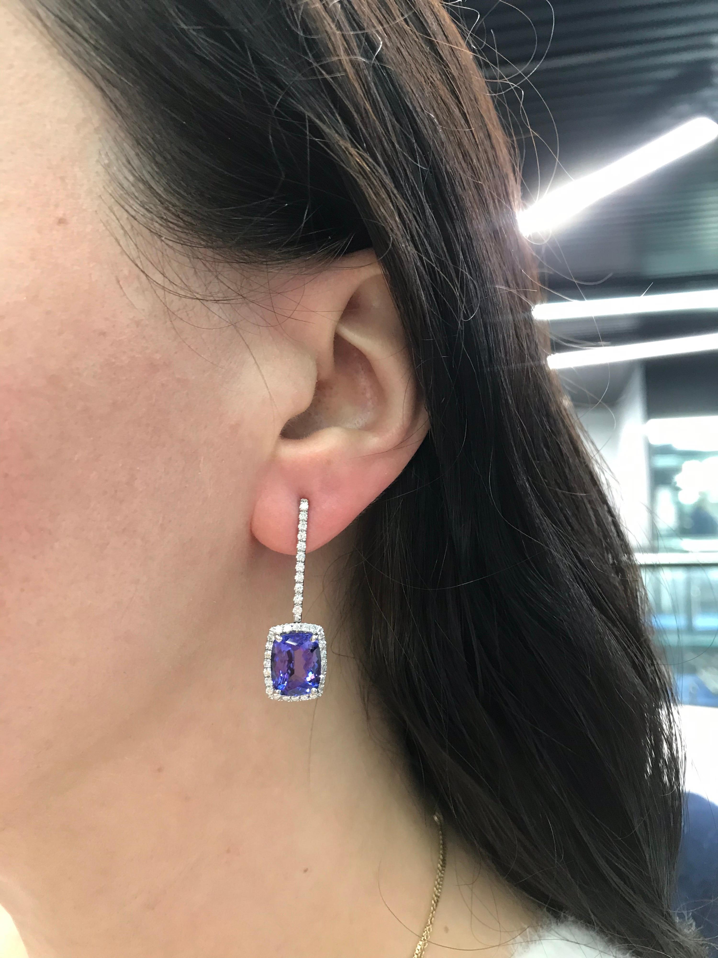 An elegant pair of 18K white gold drop earrings featuring two cushion cut Tanzanite weighing 8 carats flanked with round brilliants weighing 1.50 carats.
Color G-H
Clarity SI

Tanzanite: 
10.73 * 8.9 MM

Tanzanite With Halo:
13.6 * 11.2 MM