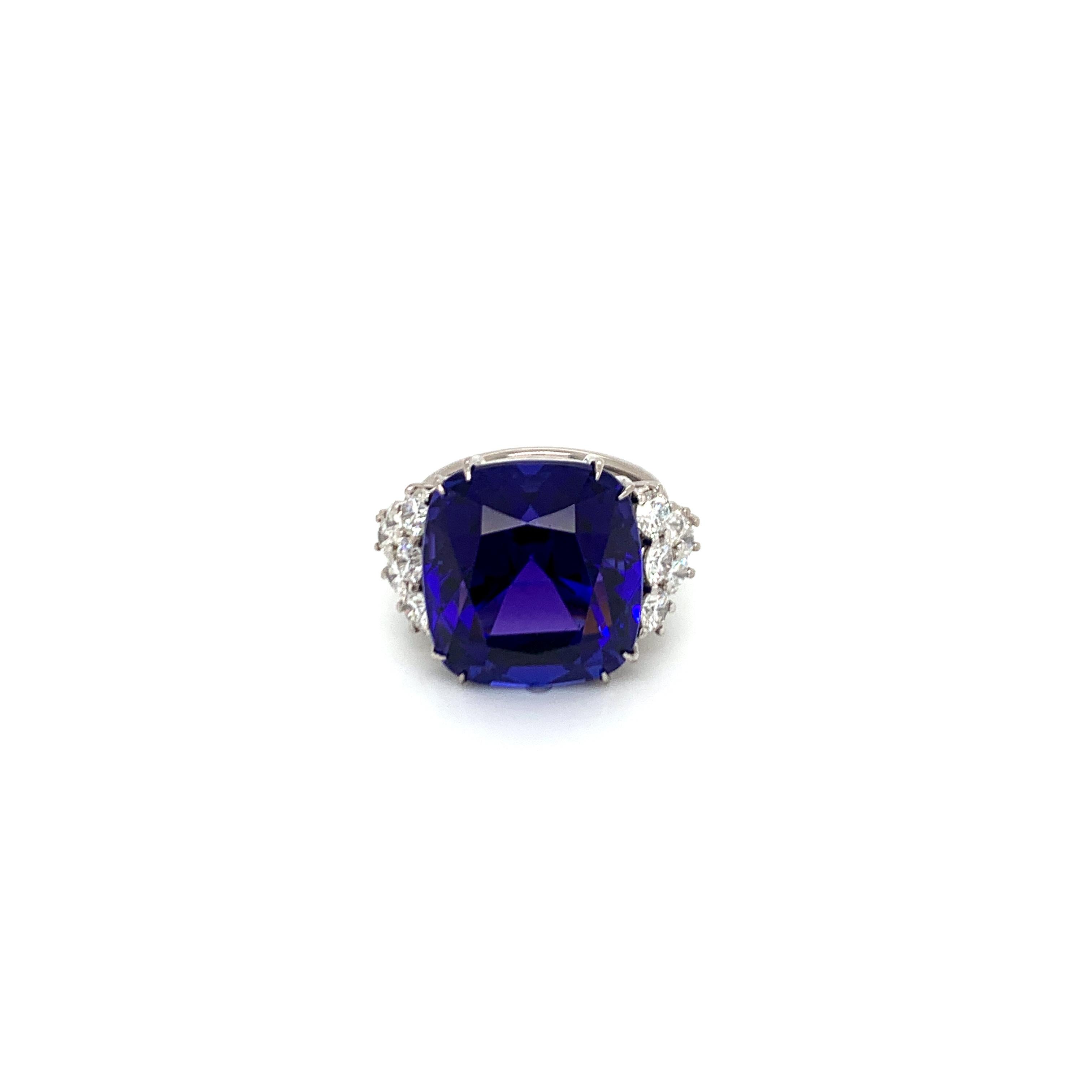 Bold and classic, this ring is a strong burst of color.  Easily wearable and definitely impressive.

1 cushion cut tanzanite 22.56cts
12 round diamonds 1.75cts
18kt white gold

Complimentary overnight delivery and the finest Italian suede and