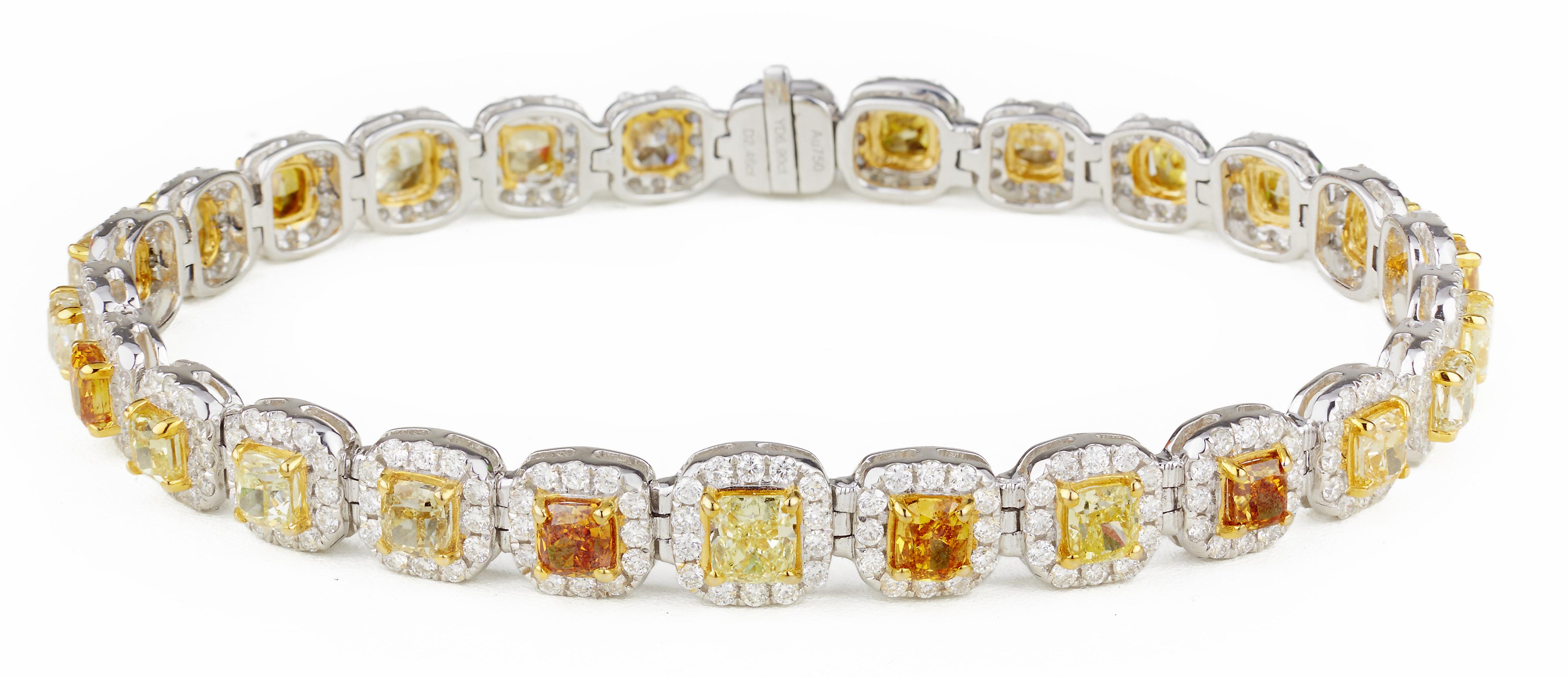 Cushion-Cut Diamonds, 6.90cts of different shades of  Yellow Diamonds each surrounded by 2.46cts of G color, VS2 clarity white diamond halo, 18kt white gold
