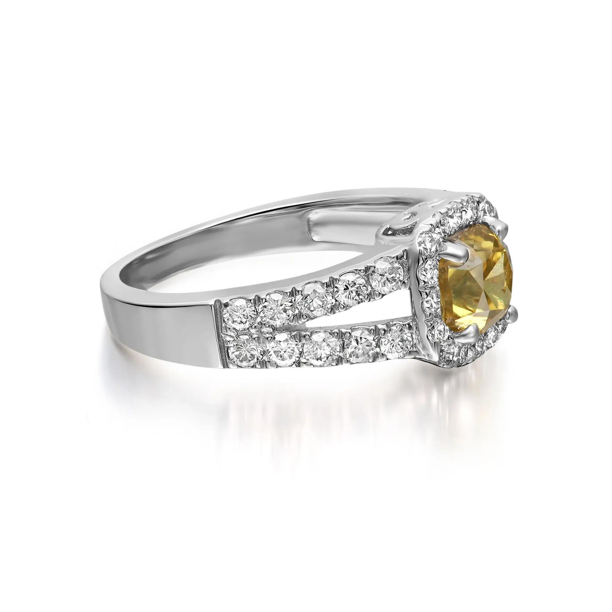 This stunning engagement ring comes with a flashy statement look. A must have in your jewelry collection. The ring is crafted in 18K white gold. Showcases a prong set cushion cut yellow diamond in the center weighing 1.00 carat, accented with round