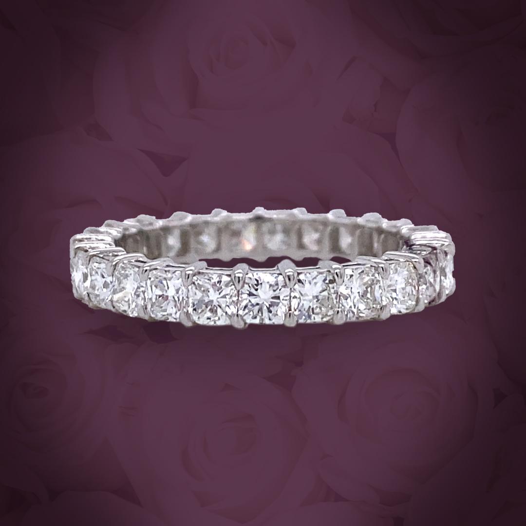 This Petite cushion diamond eternity band features 25 cushion diamonds.
This ring has a total carat of 2.69.
The diamonds are H color and VS clarity.
The ring is set in platinum and is a finger size 7.